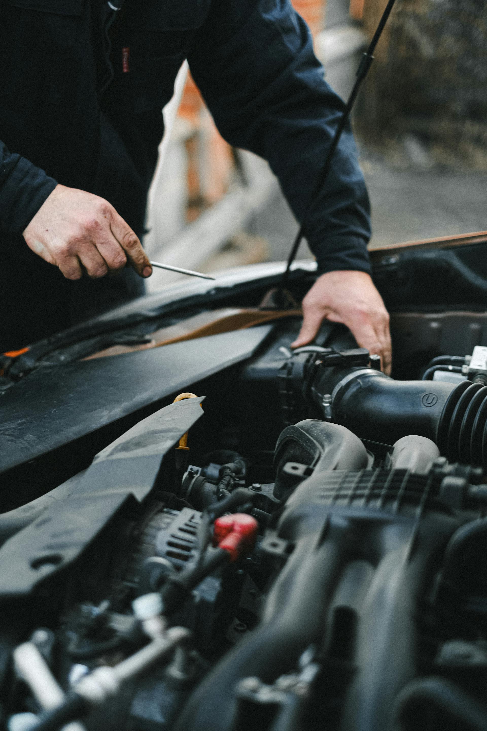 A man working on a car's engine | Source: Pexels