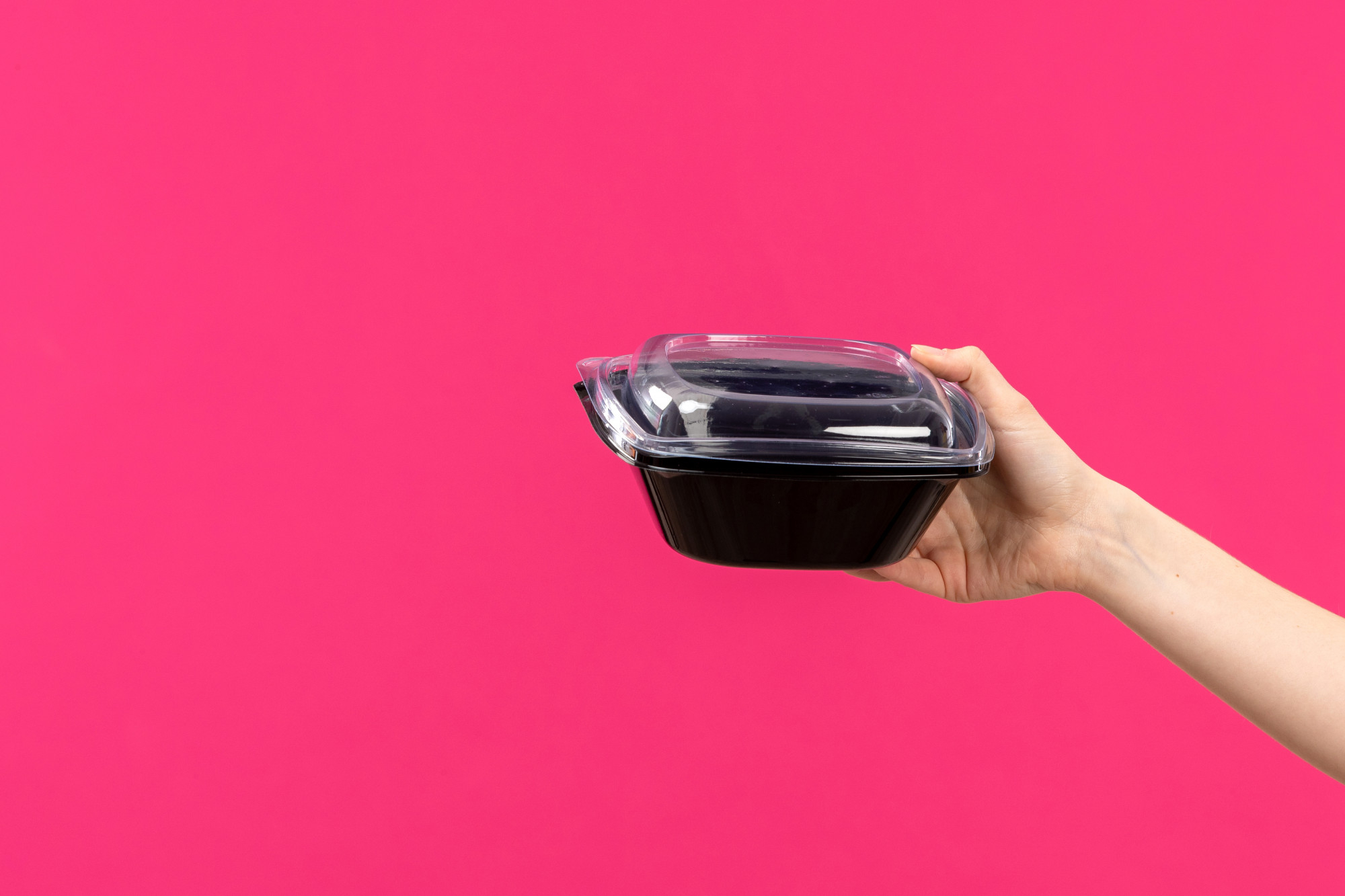 A person holding a food container | Source: Freepik