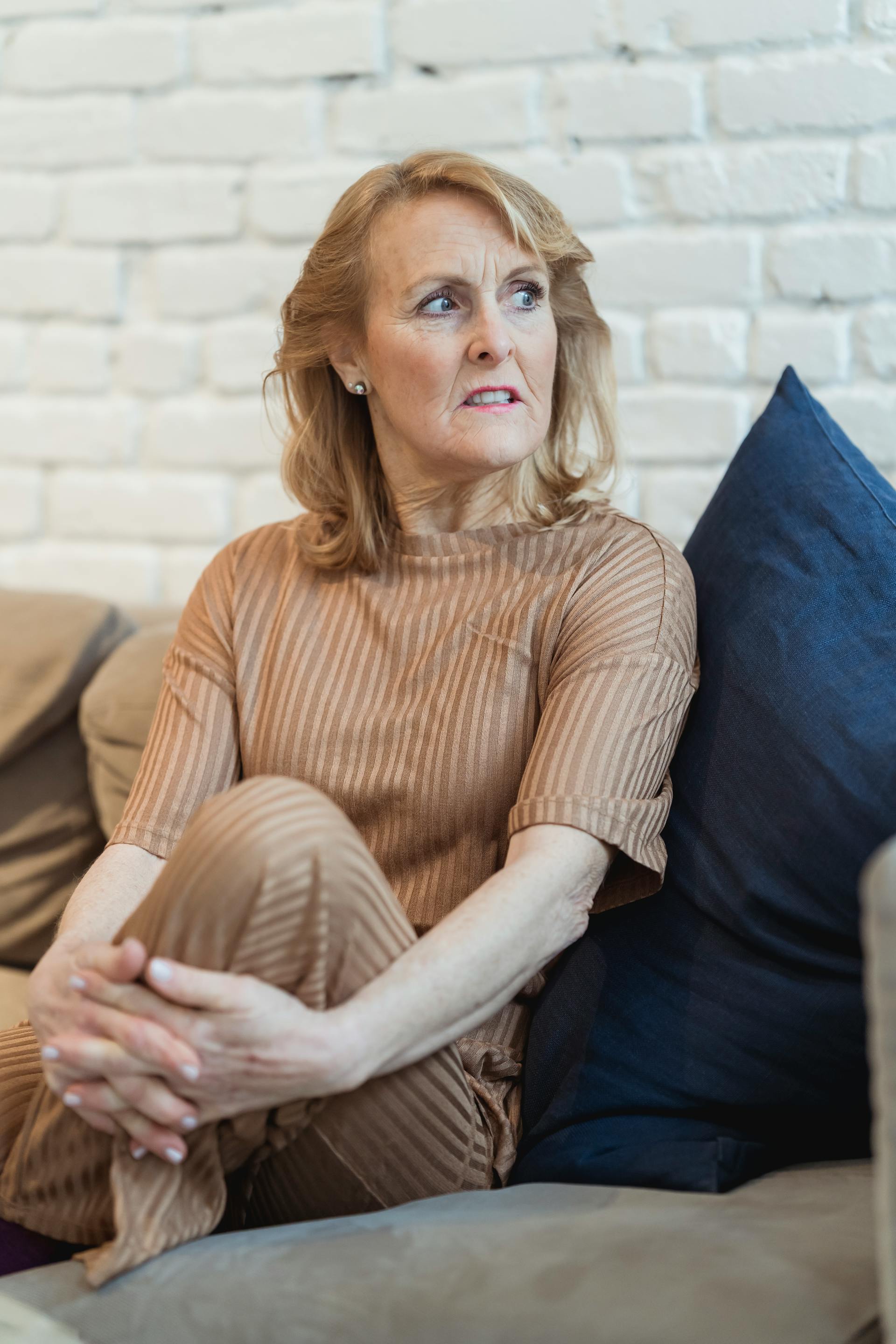 An angry woman sitting on a sofa | Source: Pexels