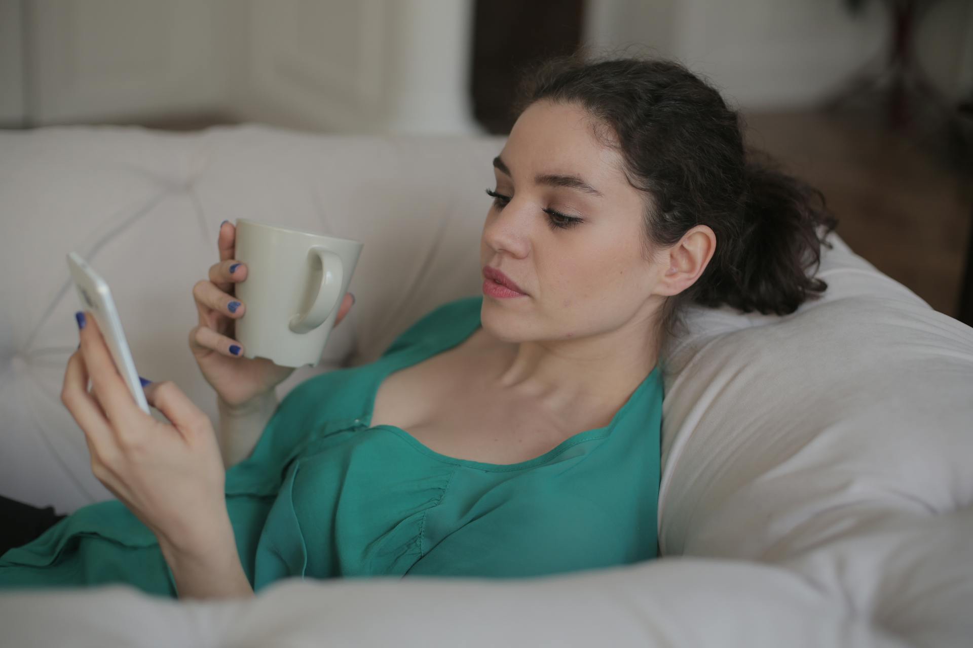 A woman scrolling on her cell phone | Source: Pexels