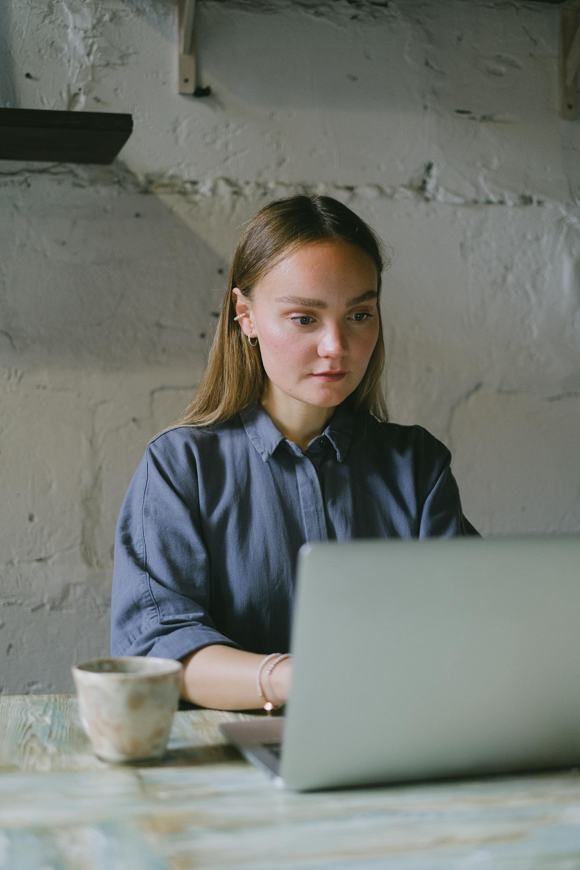 A woman staring at a laptop screen in shock | Source: Pexels