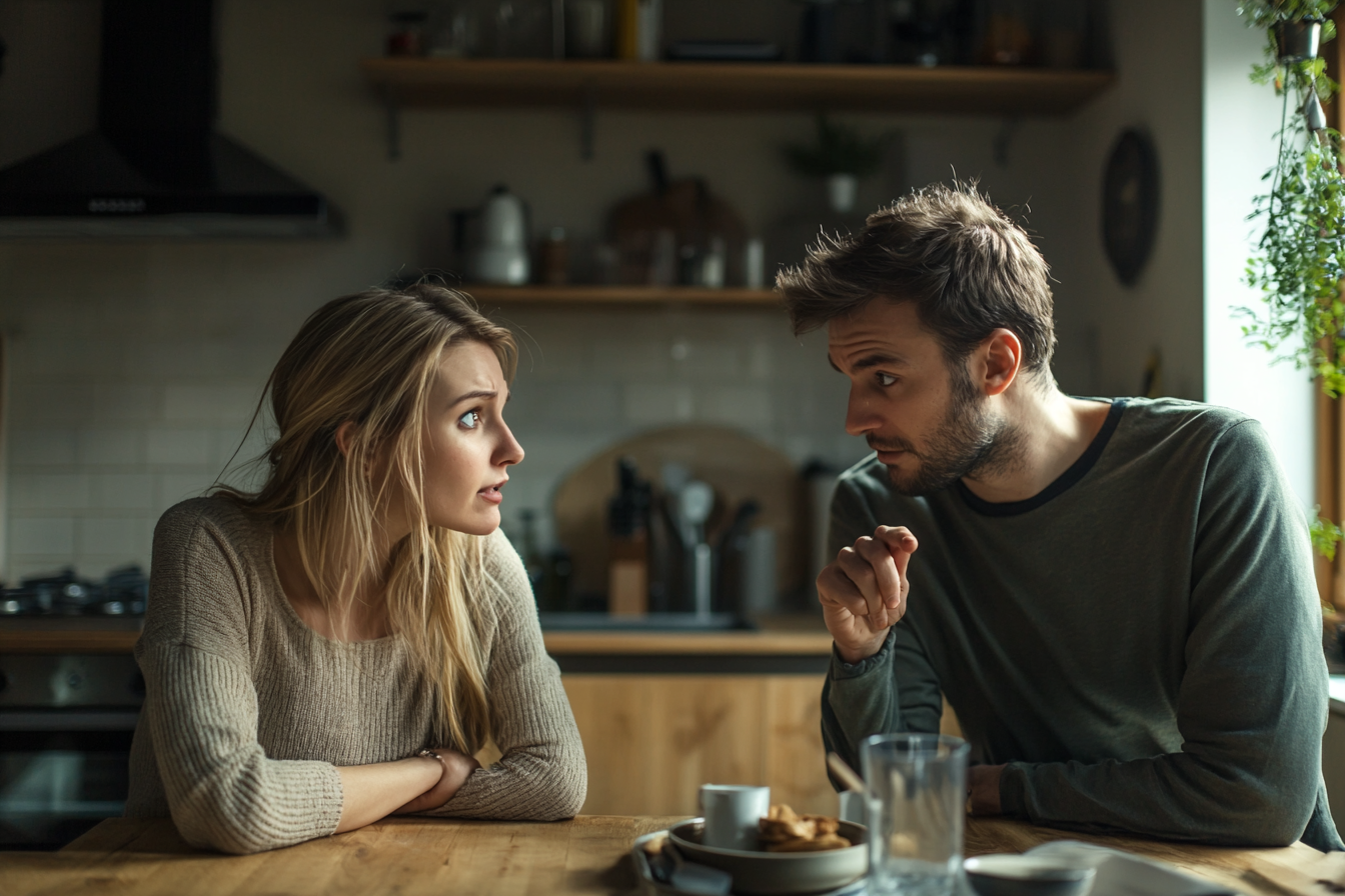 A couple speaking in their kitchen | Source: Midjourney