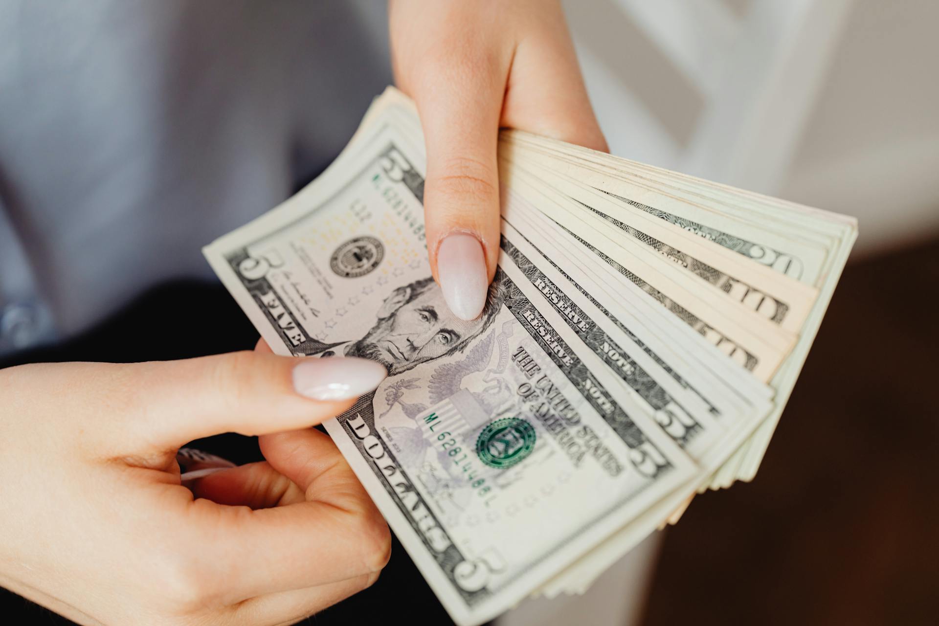 A woman holding money | Source: Pexels