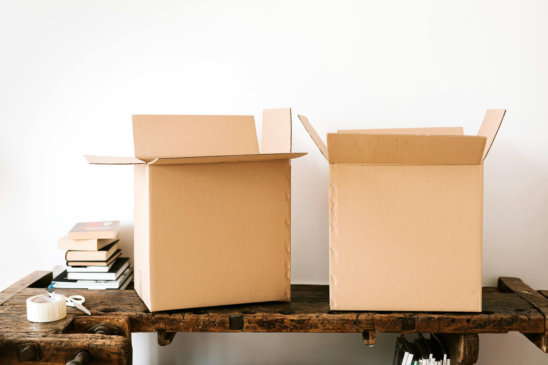 Two cardboard boxes on a table | Source: Pexels