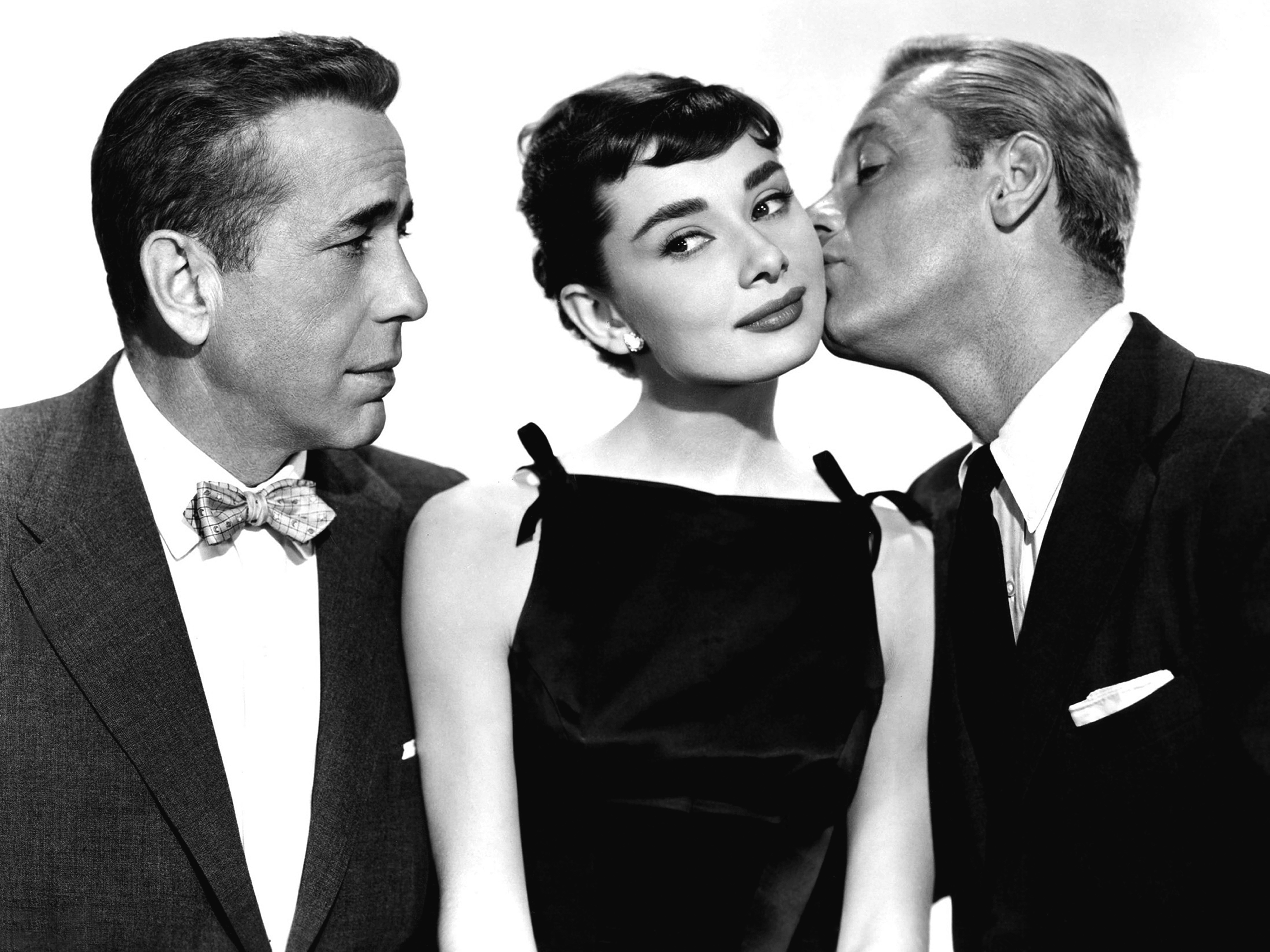 Audrey Hepburn and actors Humphrey Bogart and William Holden pose for a publicity still for the Paramount Pictures film "Sabrina" in 1954 in Los Angeles, California. | Source: Getty Images