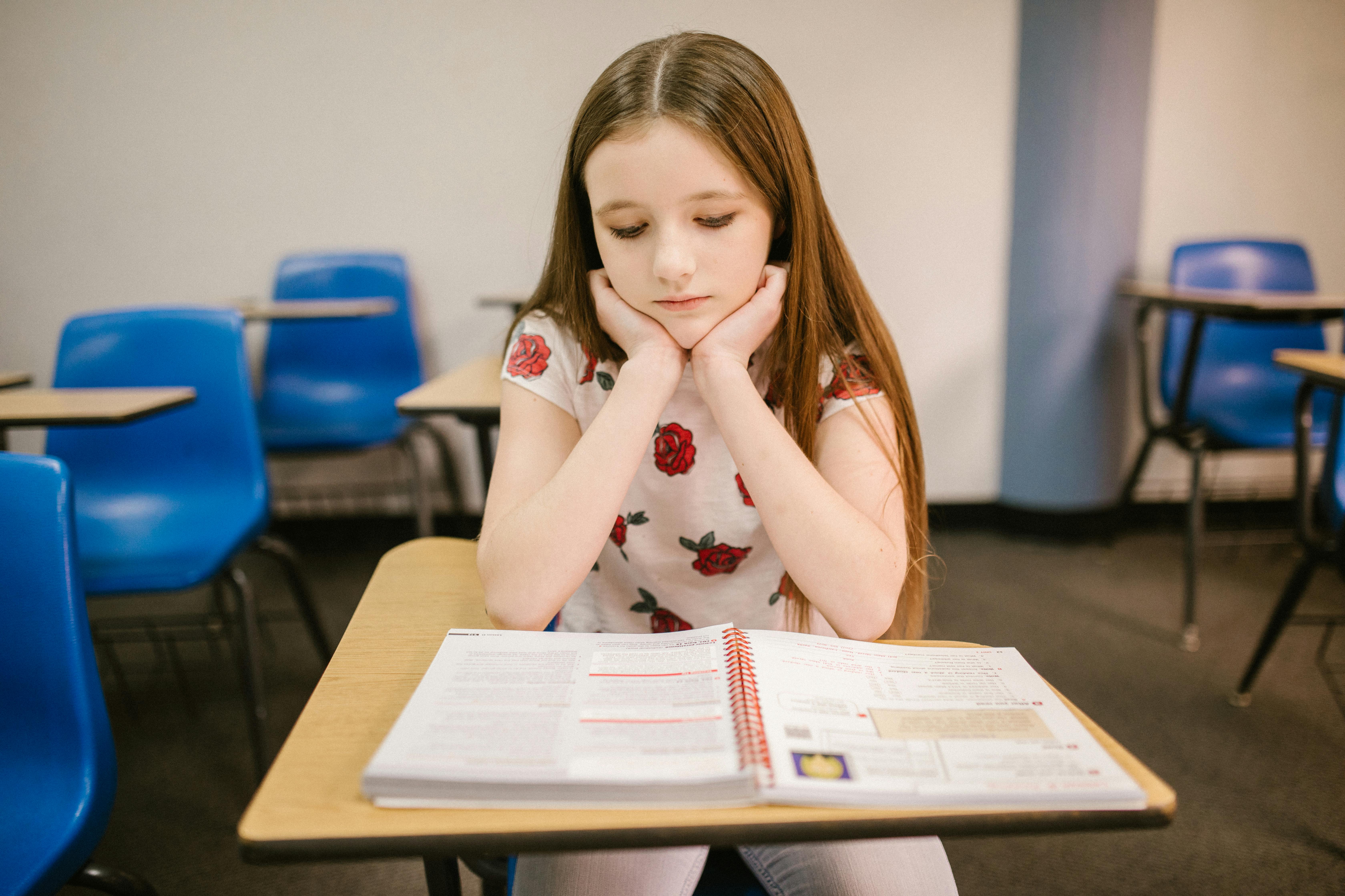 A sad girl sitting in a classroom | Source: Pexels