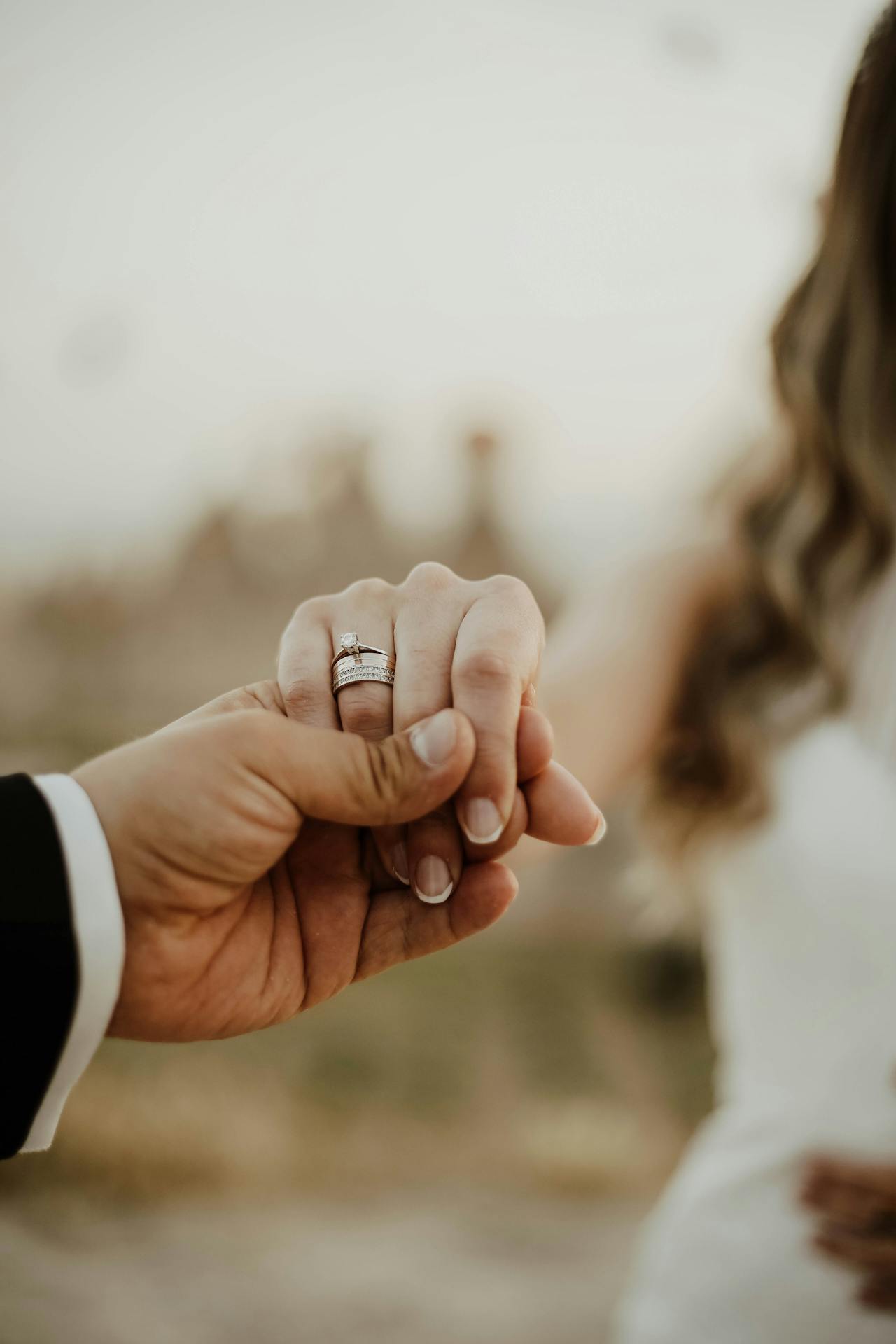 A newlywed couple holding hands | Source: Pexels