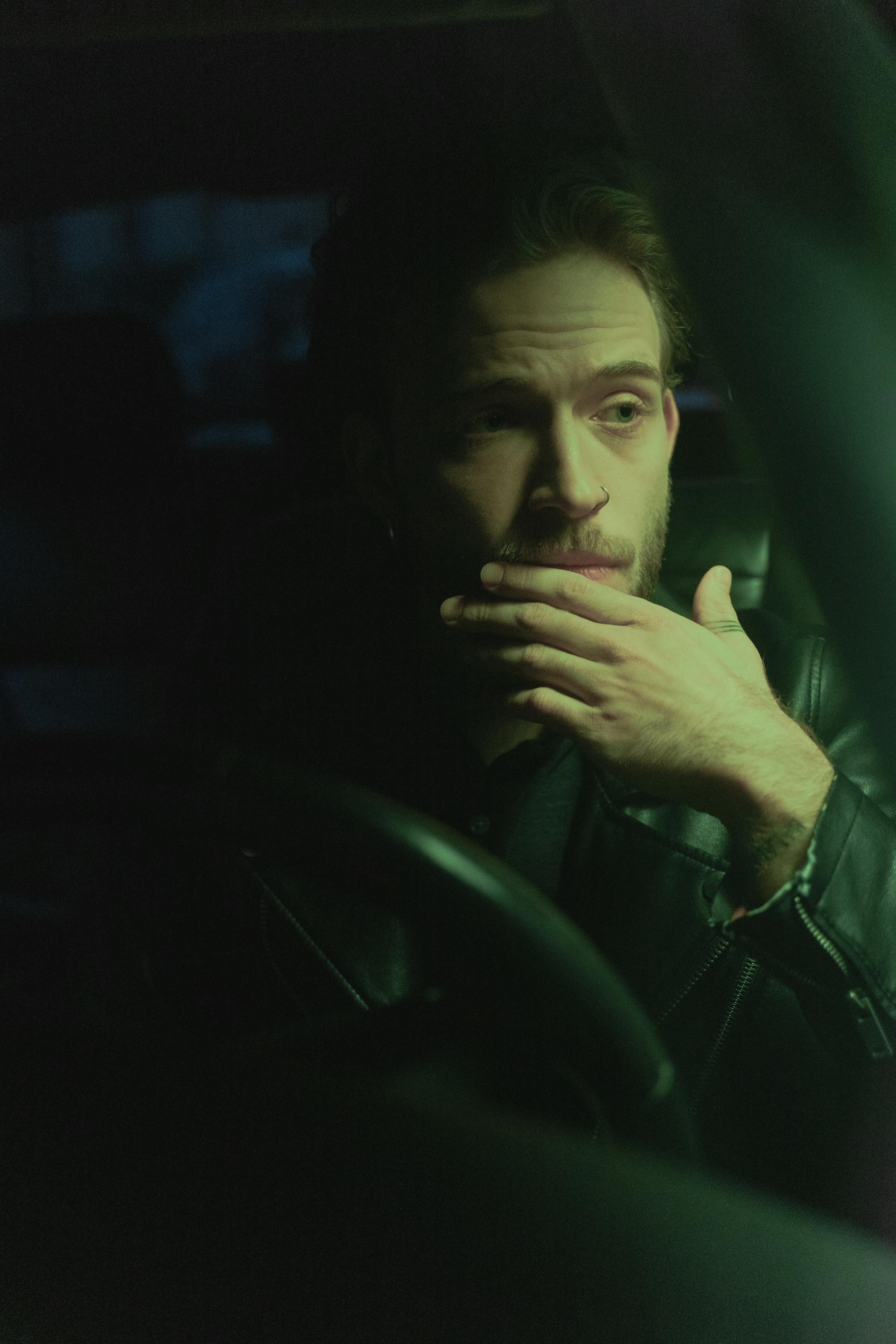 A man sitting in a car's driving seat | Source: Pexels