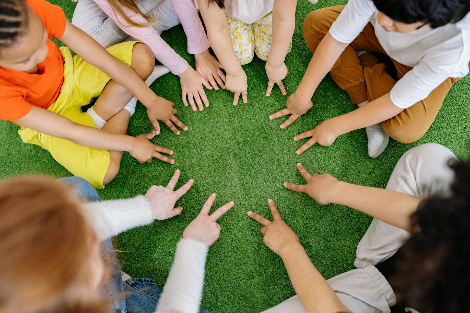 Kids sitting on grass | Source: Pexels