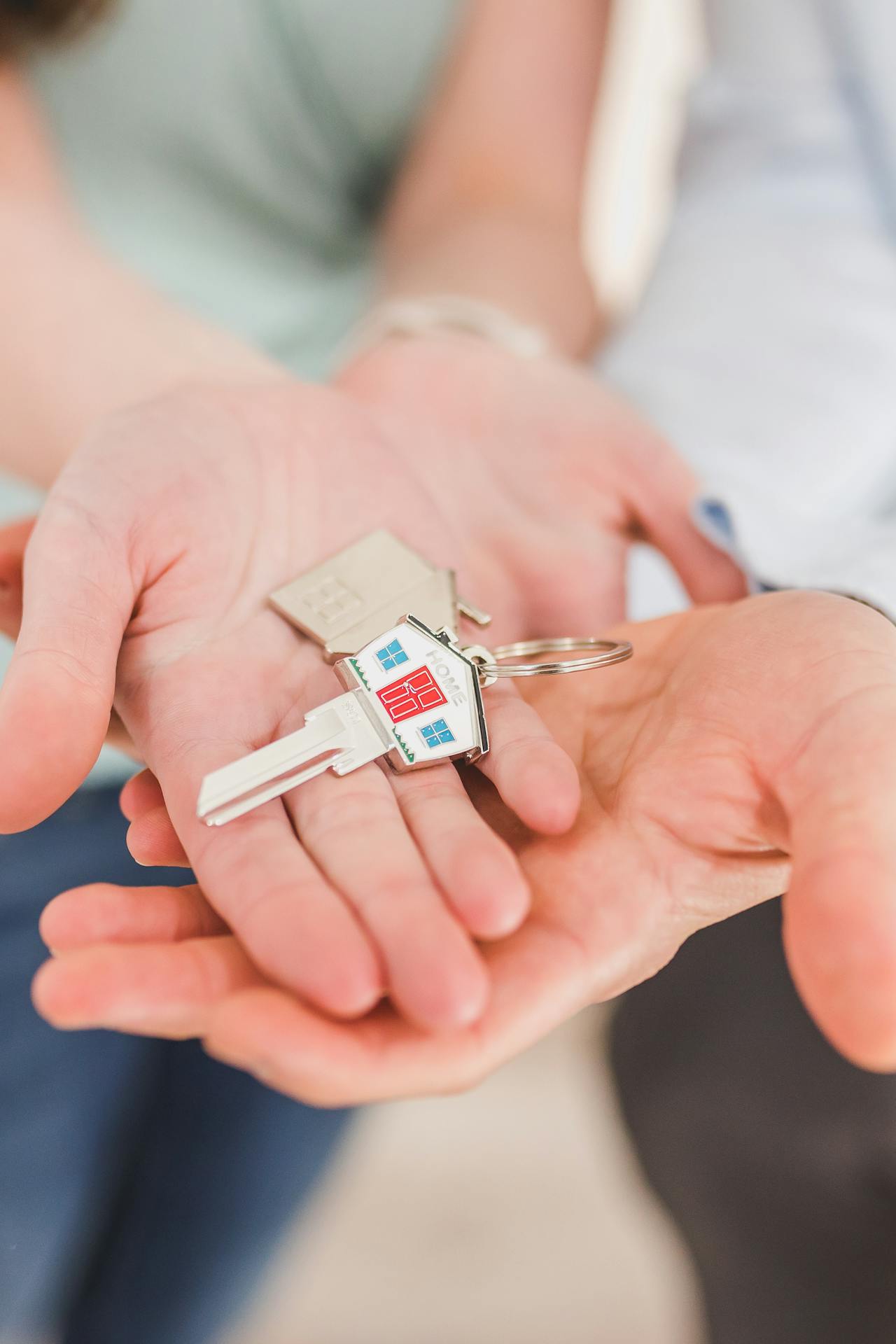 A couple holding a house key | Source: Pexels
