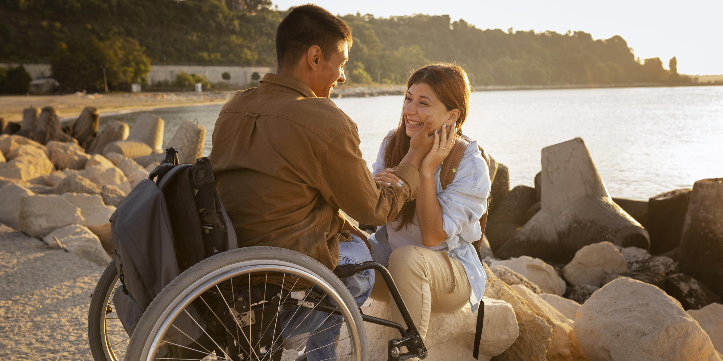 A happy woman sitting beside her husband in wheelchair | Source: Freepik