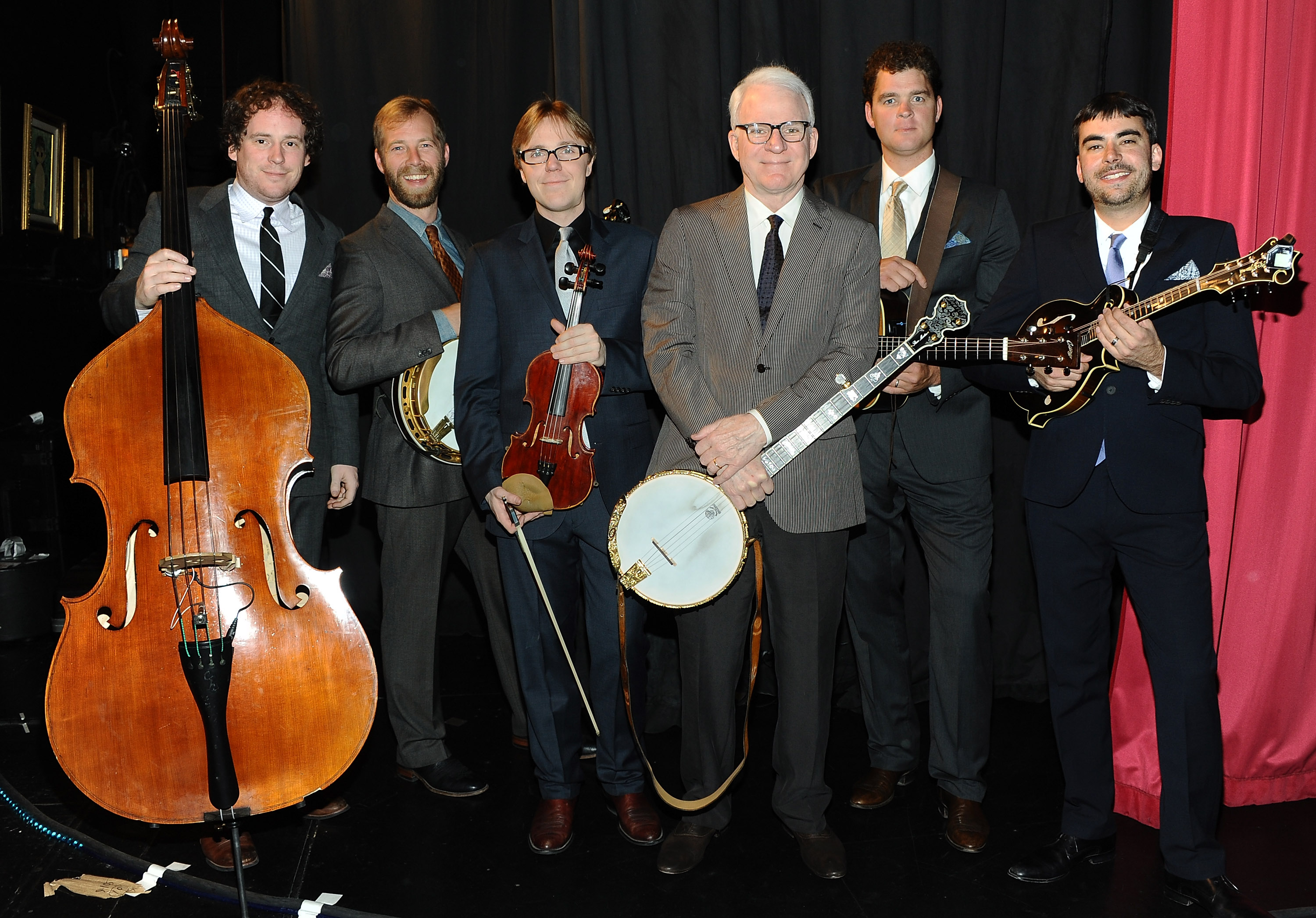 Steve Martin poses backstage with Steep Canyon Rangers at Largo at The Coronet on April 30, 2011 in Los Angeles, California | Source: Getty Images