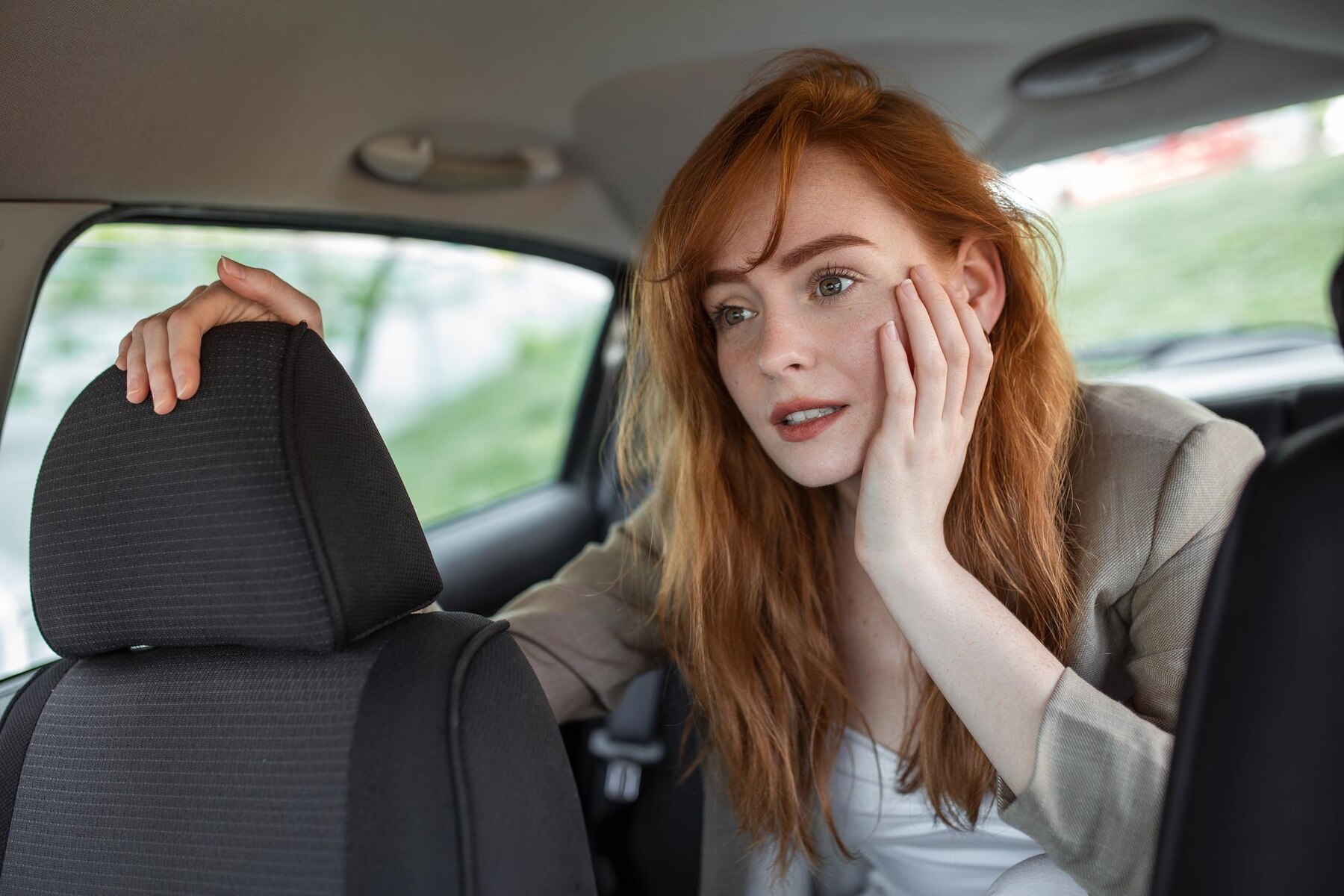 A tired woman in a car | Source: Freepik