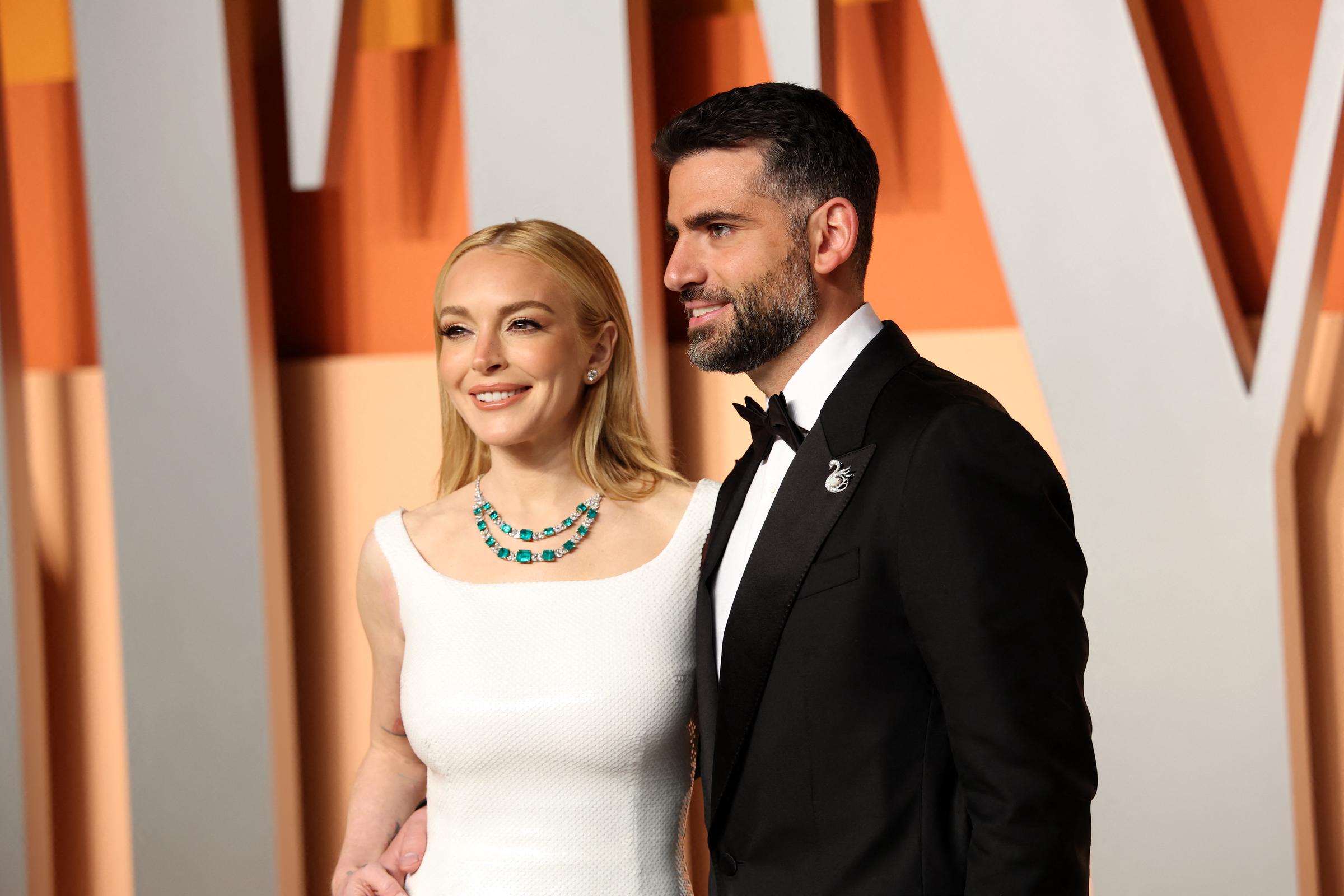 Lindsay Lohan (L) and her husband Bader Shammas attend the Vanity Fair Oscar Party at the Wallis Annenberg Center for the Performing Arts in Beverly Hills, California, on March 2, 2025. | Source: Getty Images