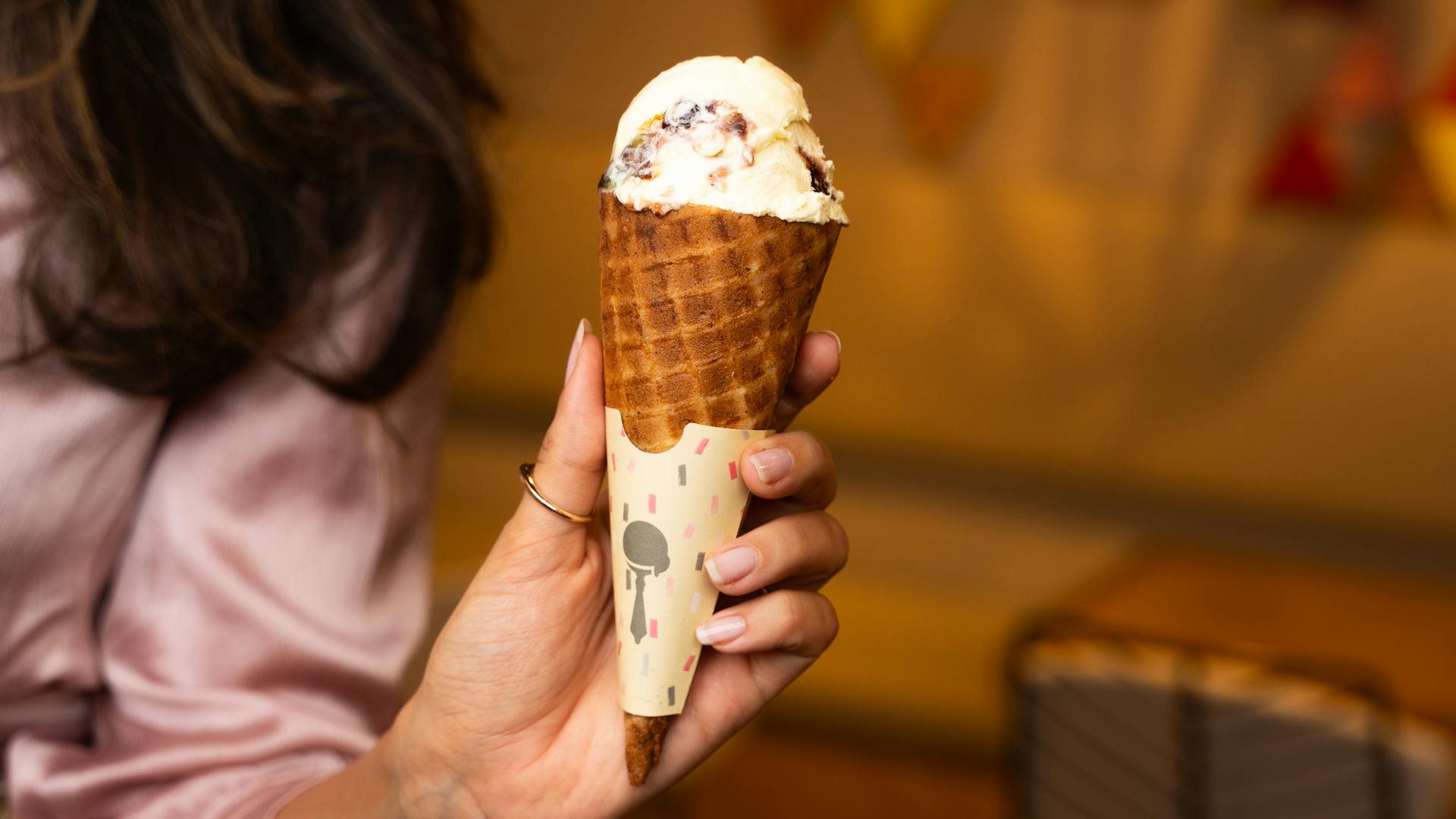 A woman holding an ice cream cone | Source: Pexels