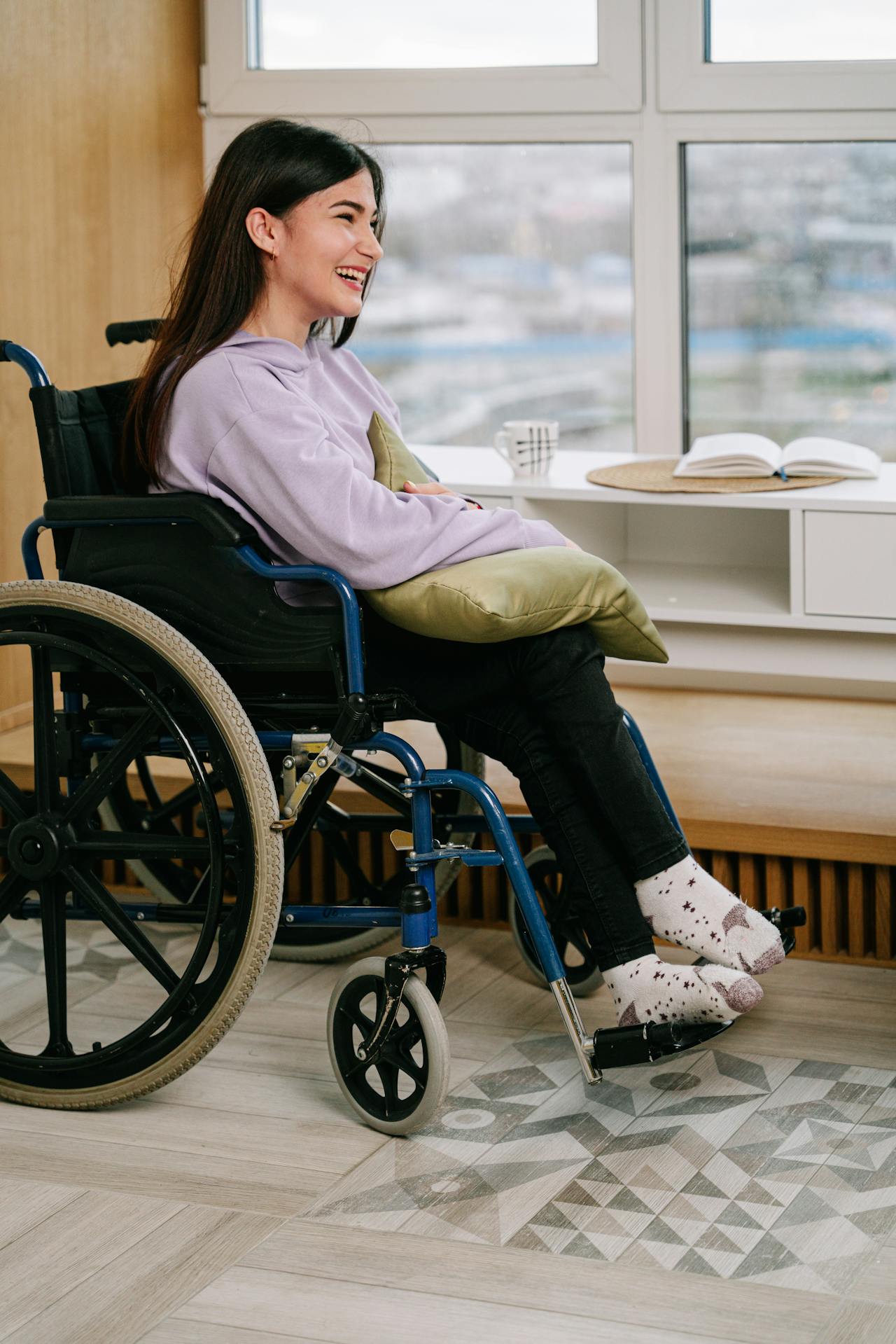A delighted woman sitting on a wheelchair | Source: Pexels