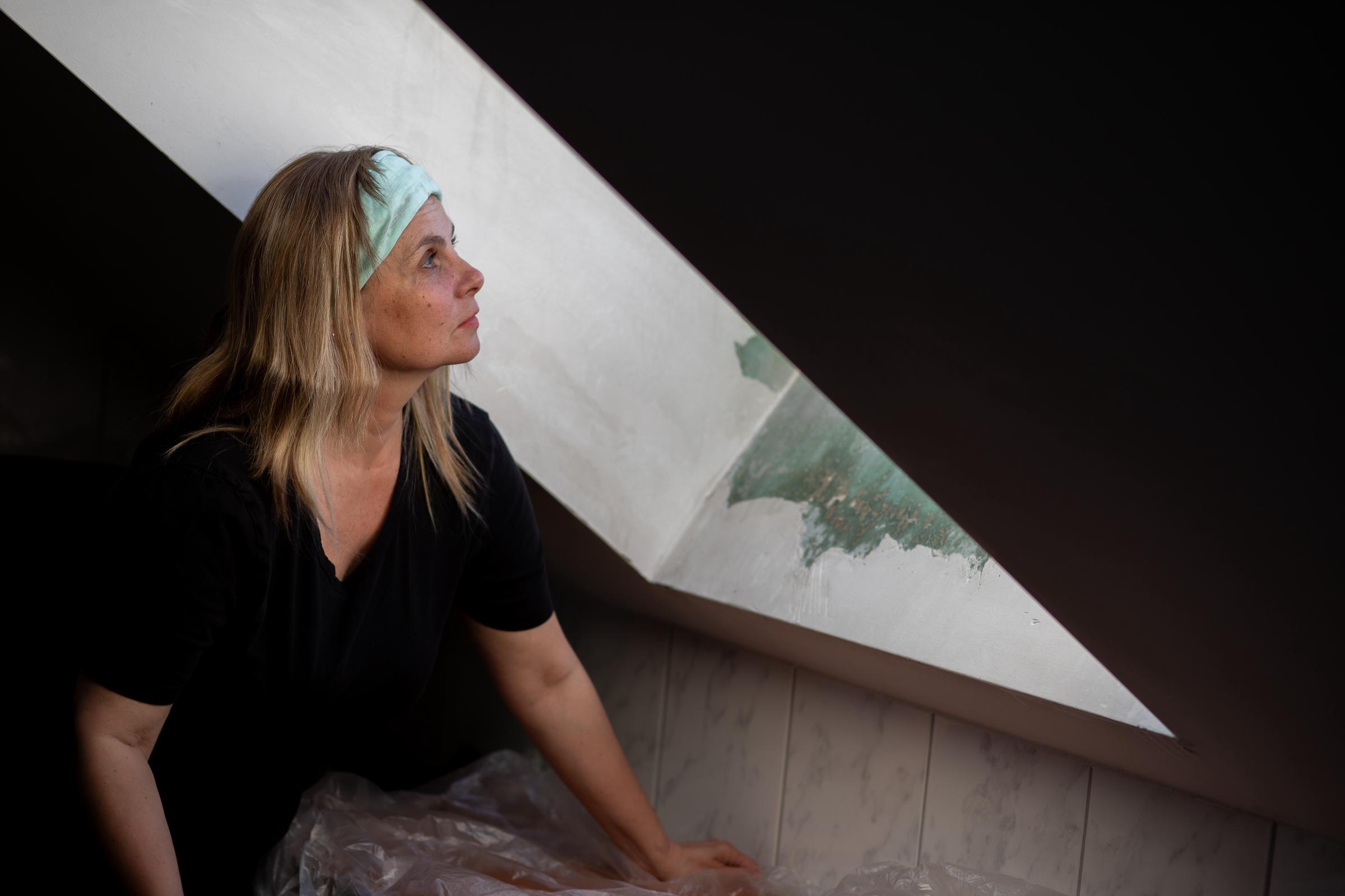 Woman looking at the attic window | Source: Shutterstock