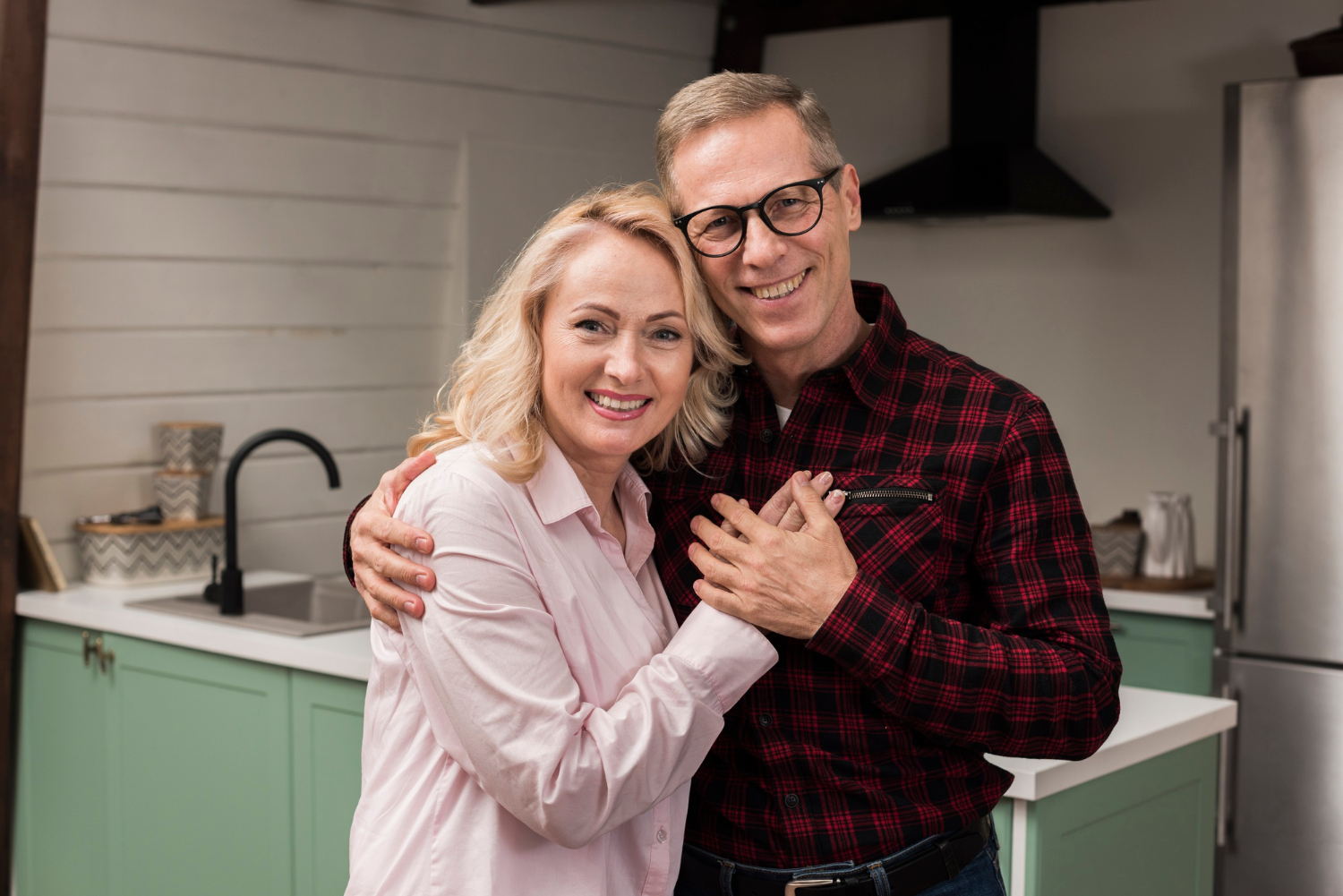 A delighted middle-aged couple embracing each other | Source: Freepik