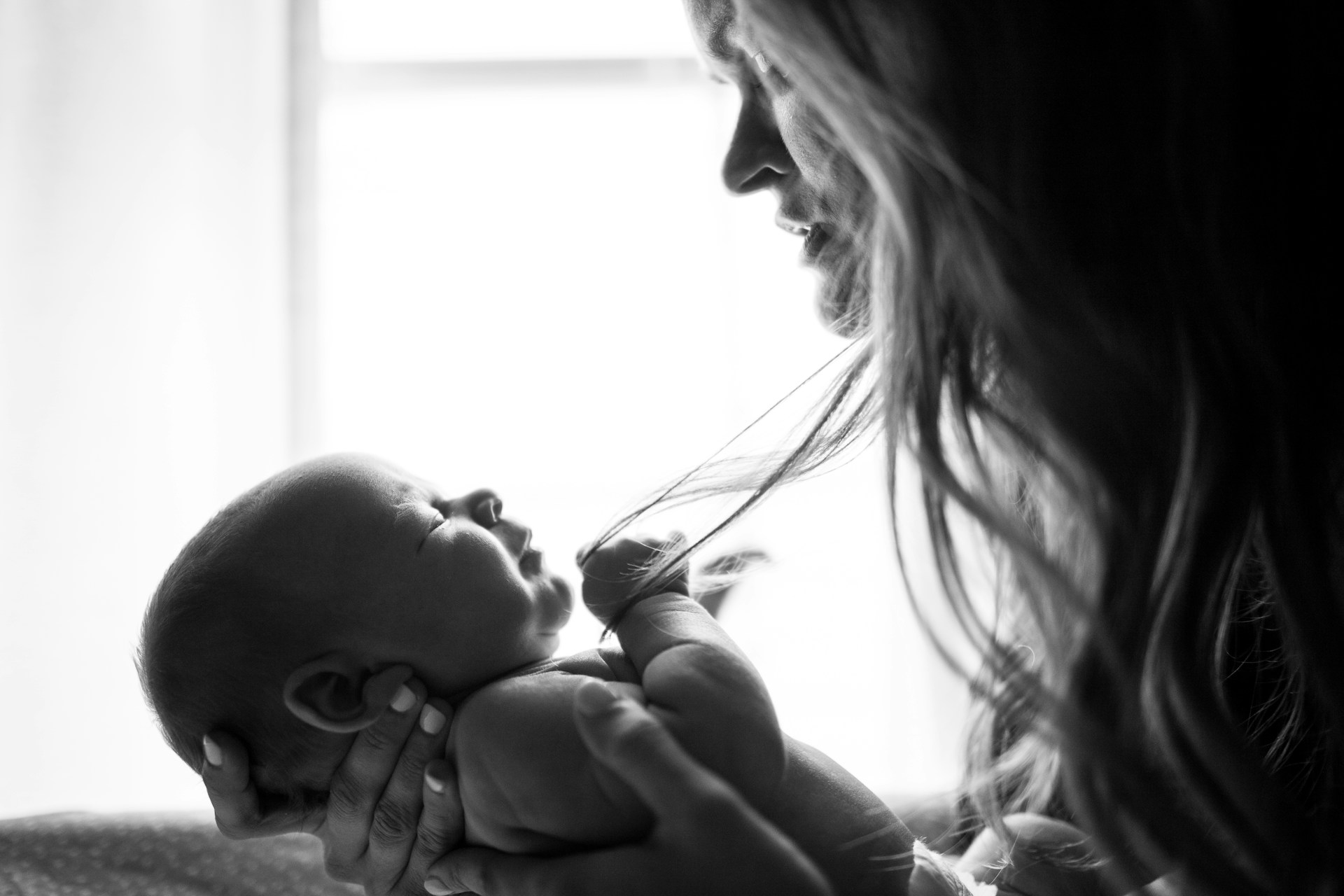 A sad mother looking at her baby | Source: Unsplash