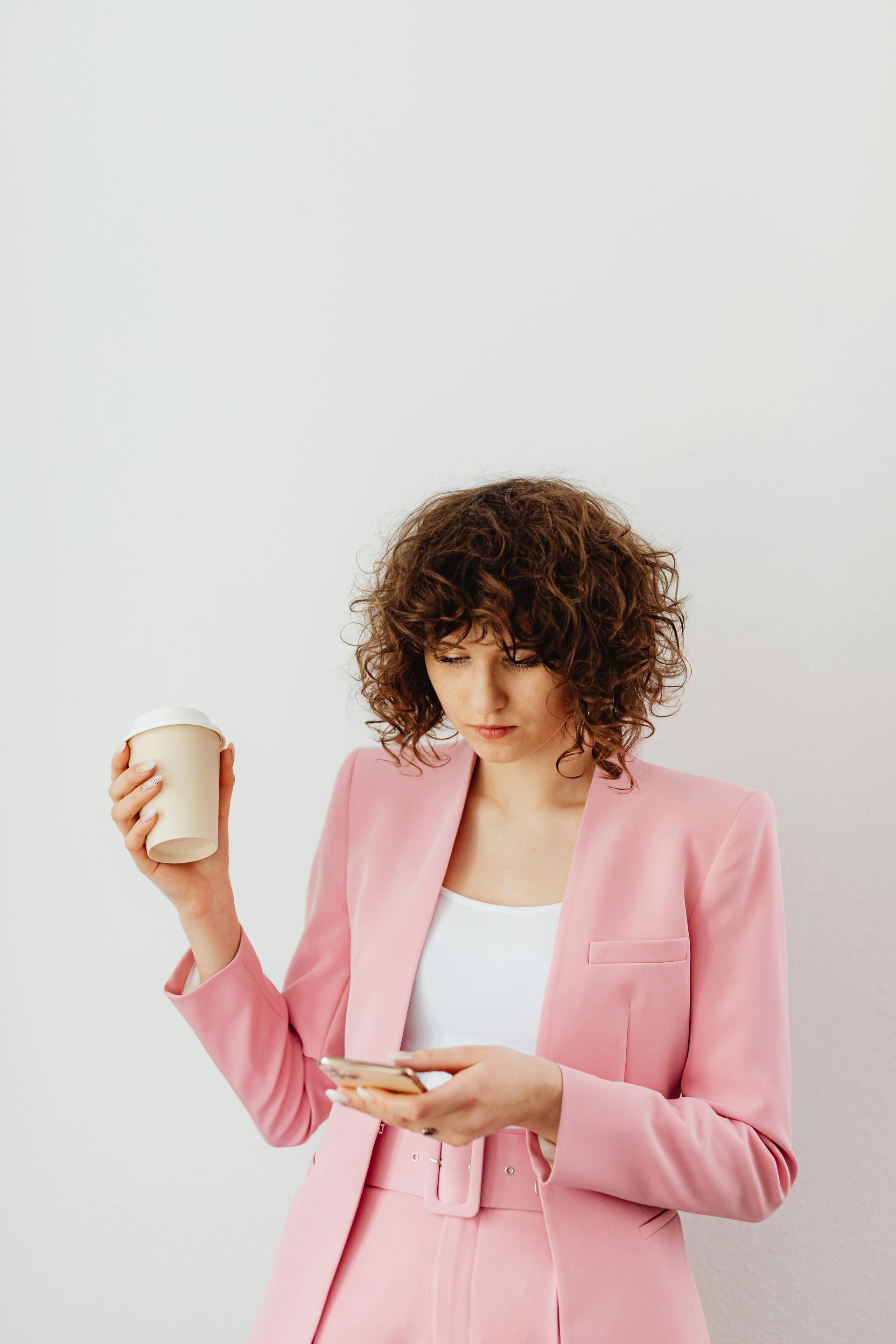 My Stepfather Told My Mom She Didn't Need Pretty Clothes Anymore – It Was His Biggest Mistake 11 A determined woman holding a coffee and phone | Source: Pexels