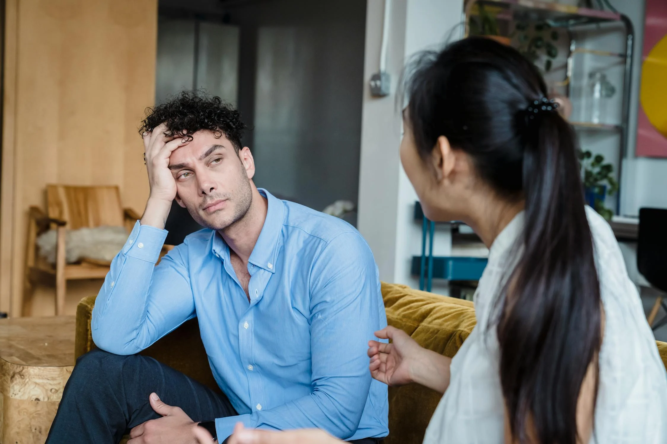 A woman talking to a man in her living room | Source: Pexels