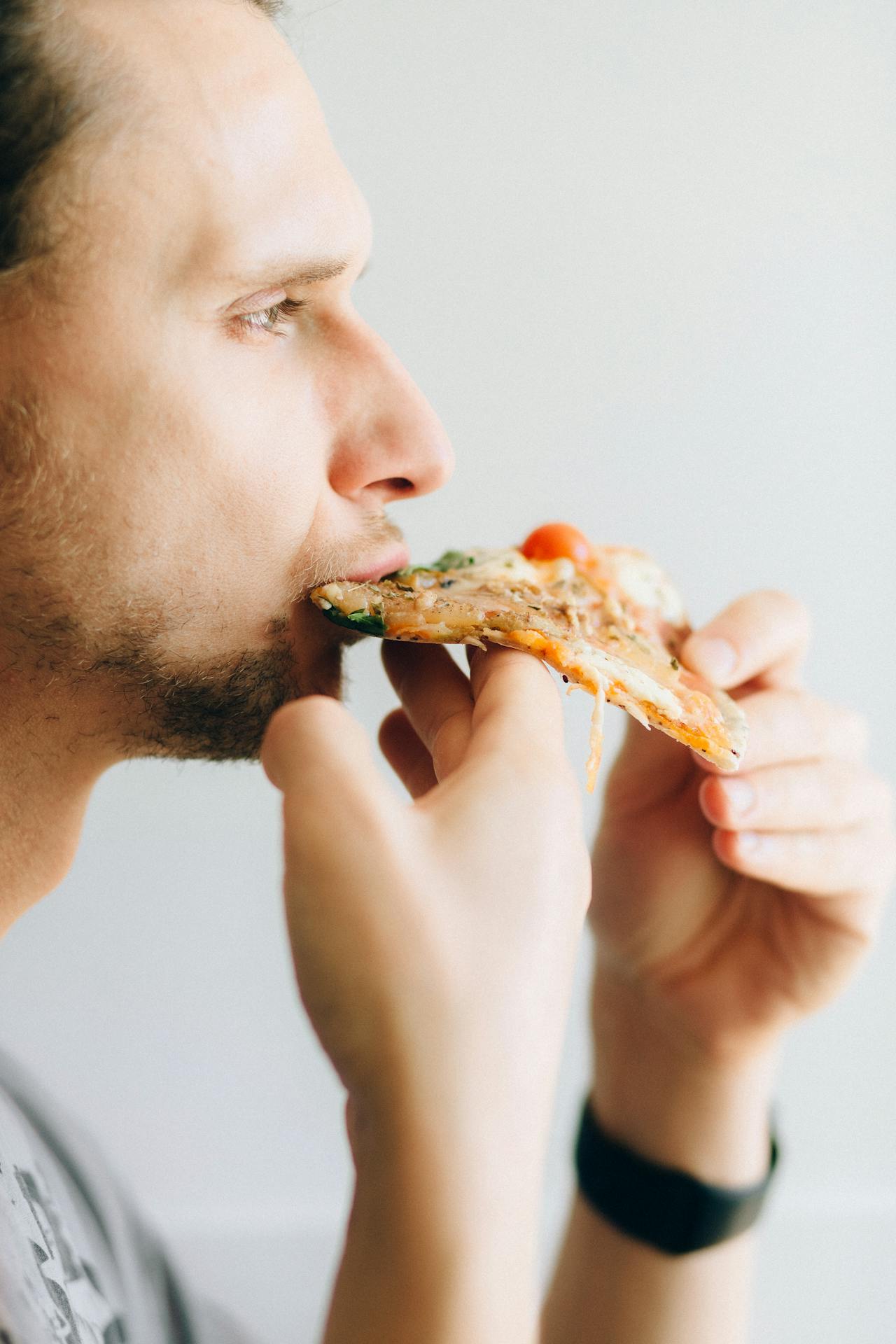 A man eating pizza | Source: Pexels