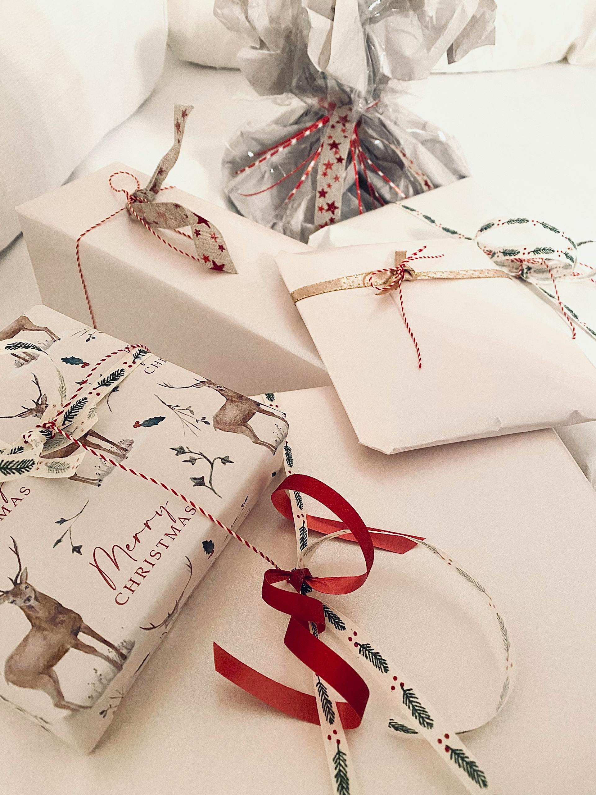 Beautifully wrapped Christmas gifts with festive ribbons | Source: Pexels