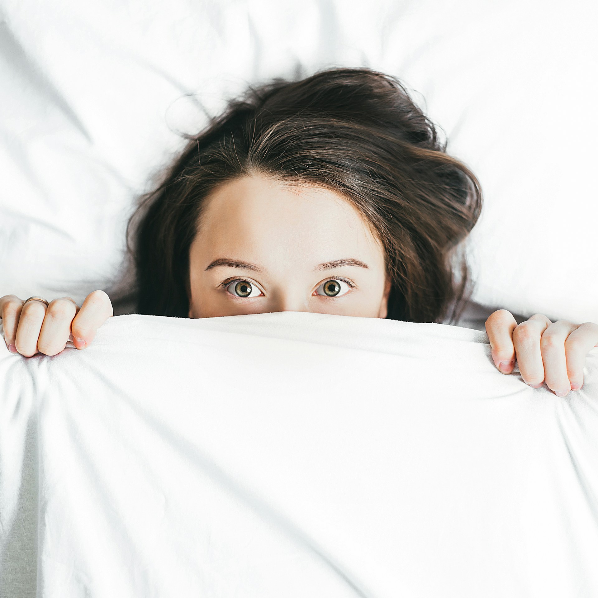 An anxious woman lying in bed | Source: Unsplash