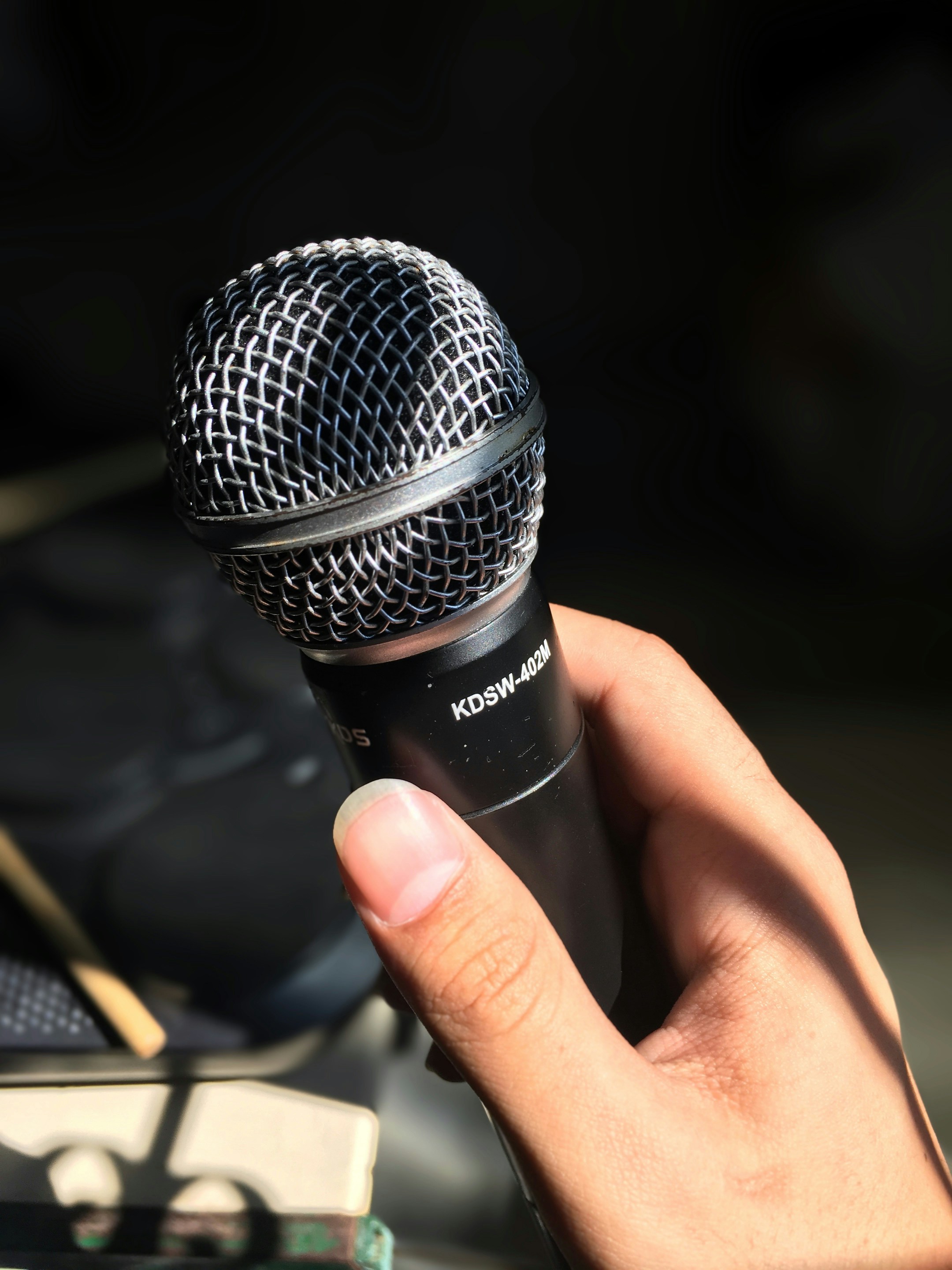 A close-up shot of a person holding a microphone | Source: Unsplash