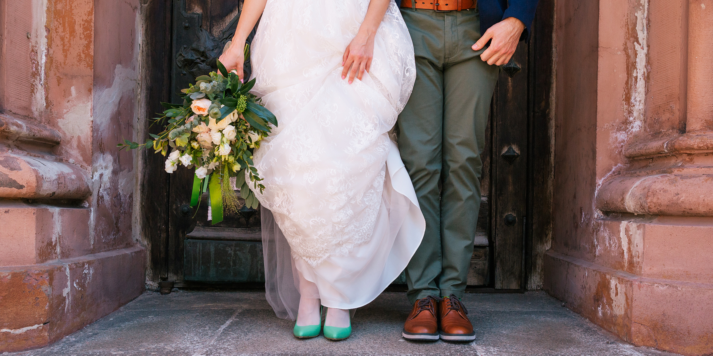 A bride and groom standing at the church entrance | Source: Shutterstock