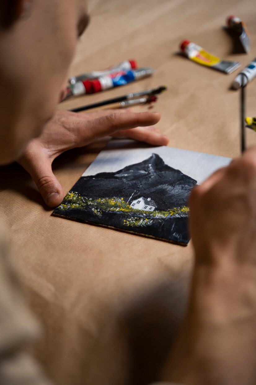 A woman holding a small painting | Source: Freepik