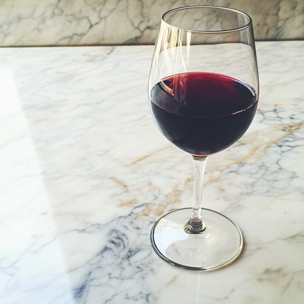 A glass of red wine | Source: Midjourney