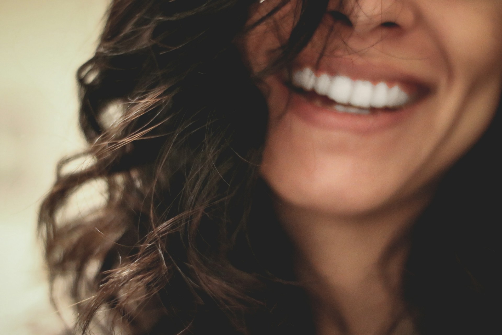 Cropped shot of a woman laughing | Source: Unsplash