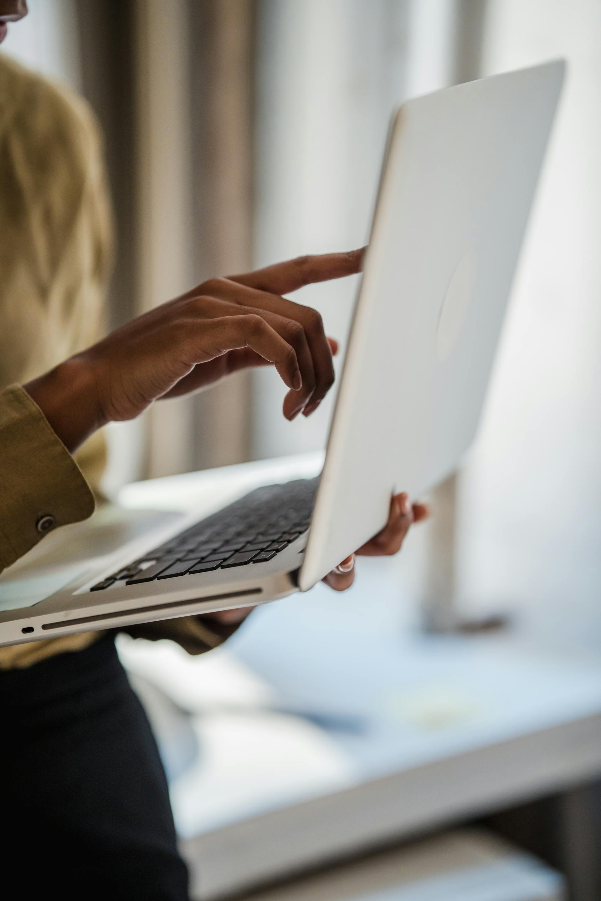 A woman holding a laptop | Source: Pexels