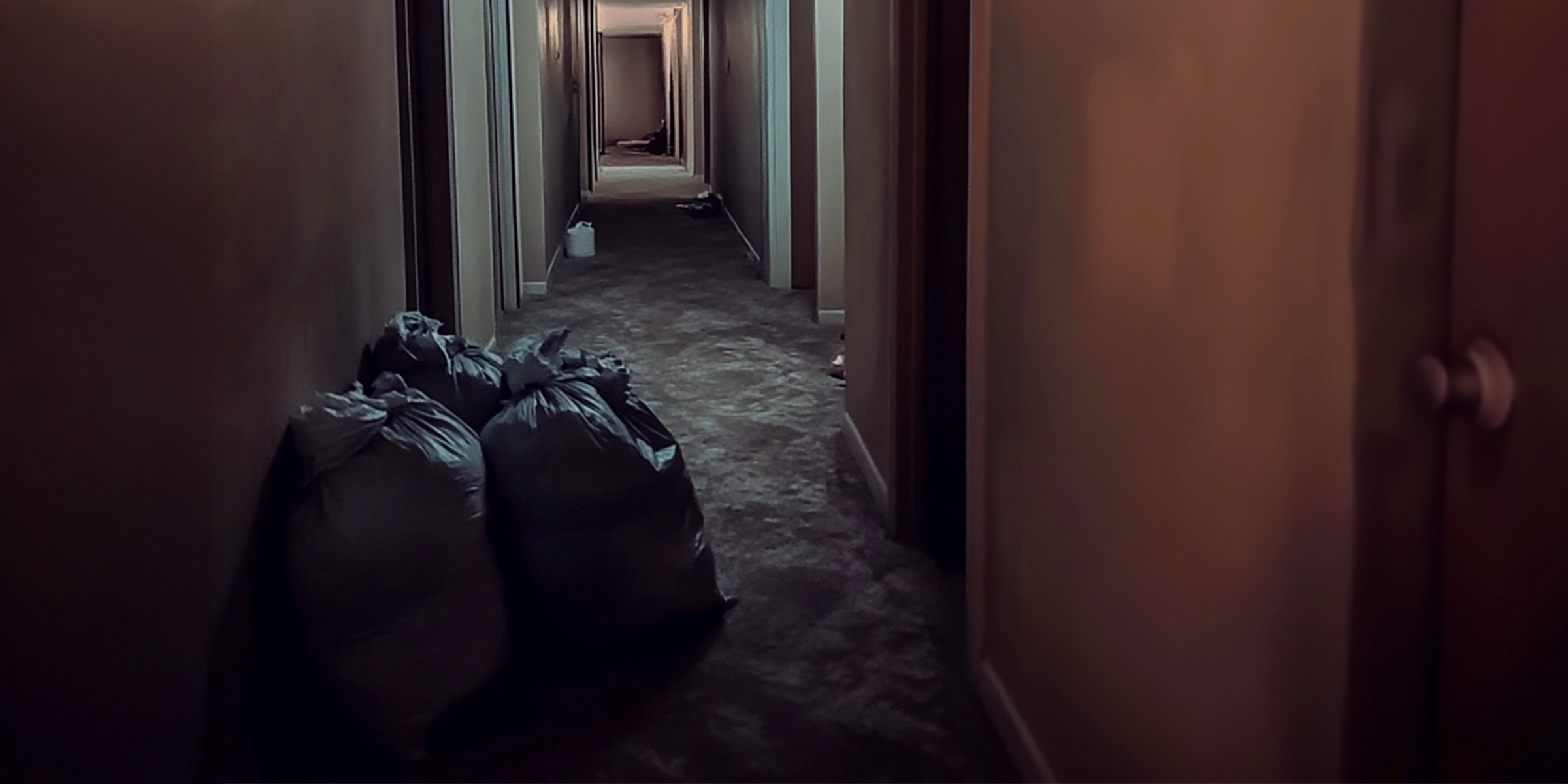 Trash bags outside an apartment's door | Source: Amomama