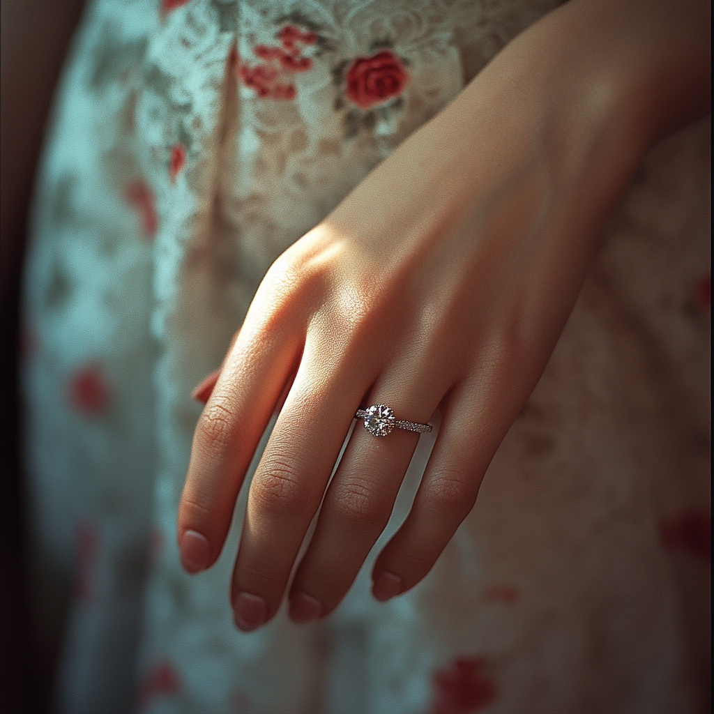 A woman's hand showing off her engagement ring | Source: Midjourney