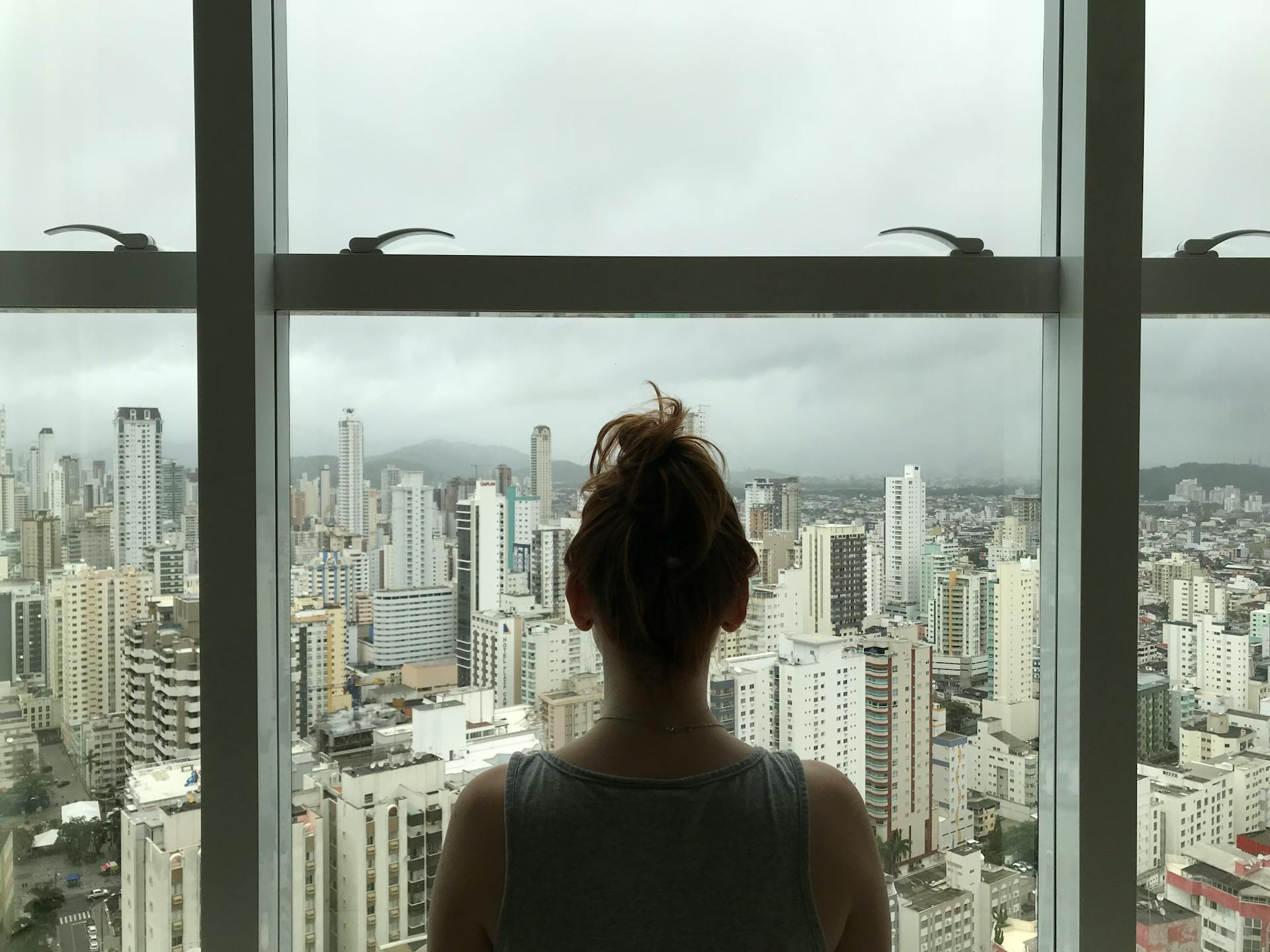 A woman standing near a window | Source: Pexels