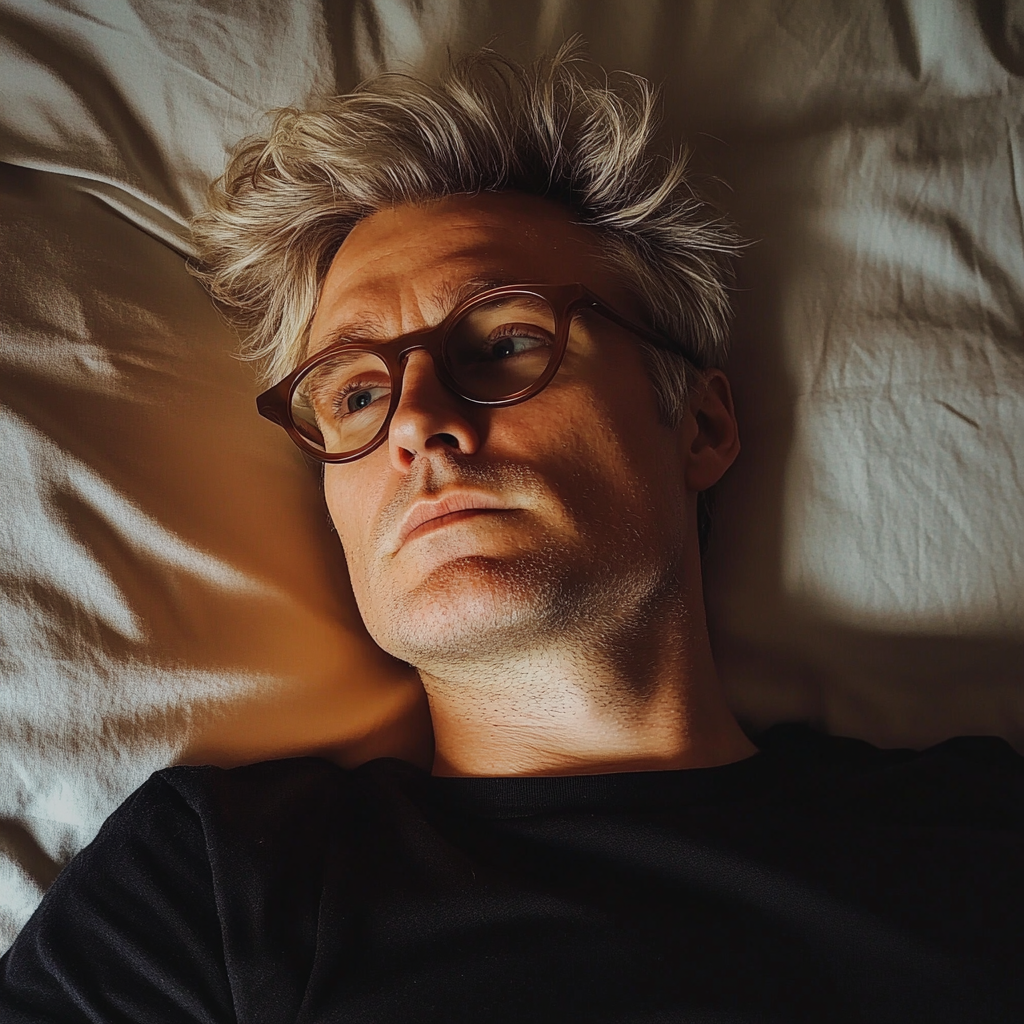 A man laying on a bed | Source: Midjourney