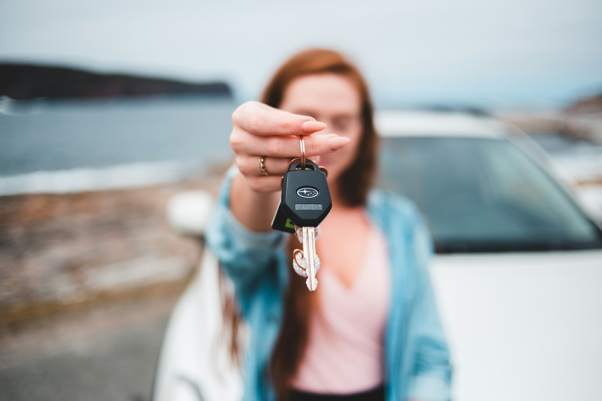 A woman holding a car key | Source: Unsplash