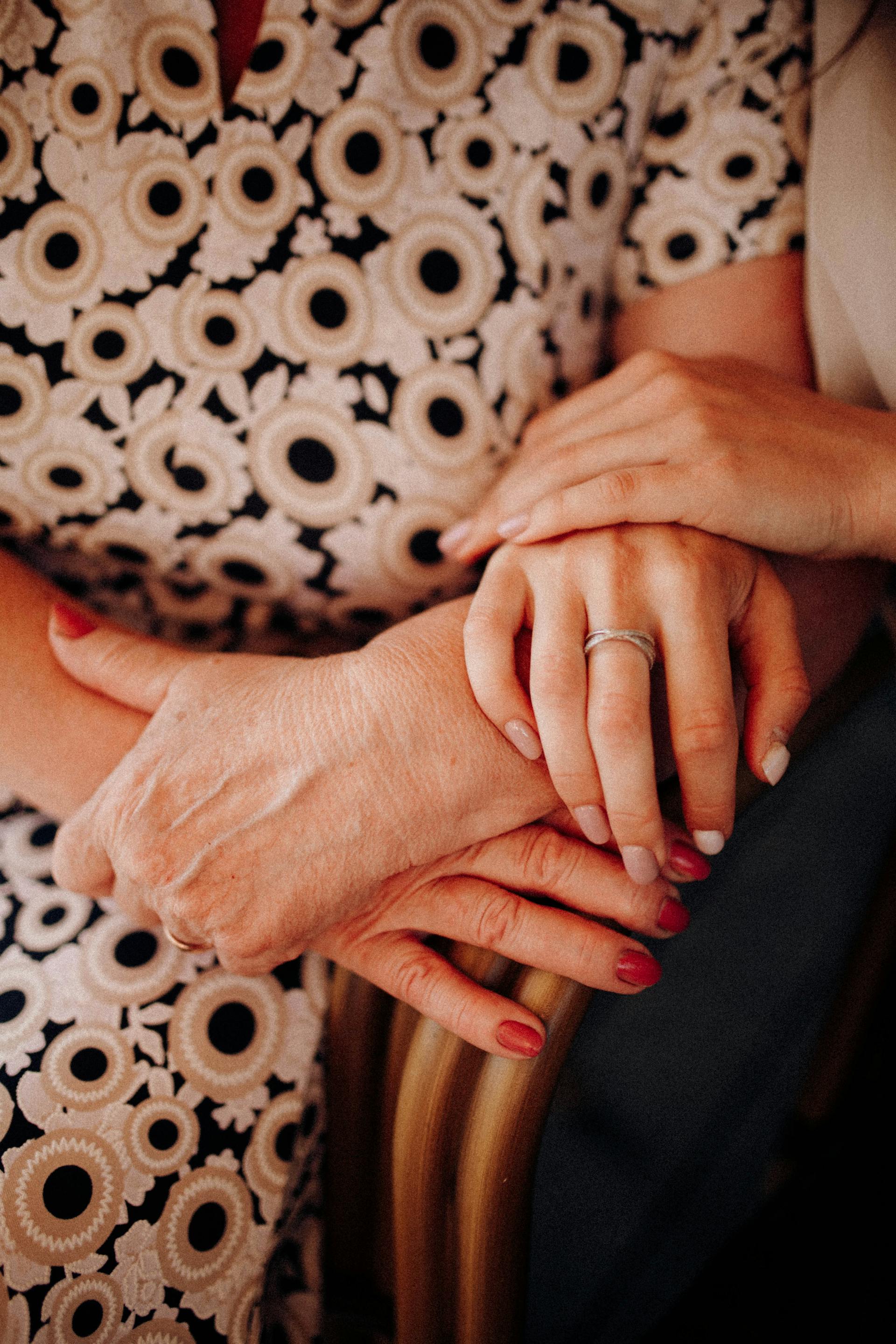 A woman holding her mother's hands | Source: Pexels