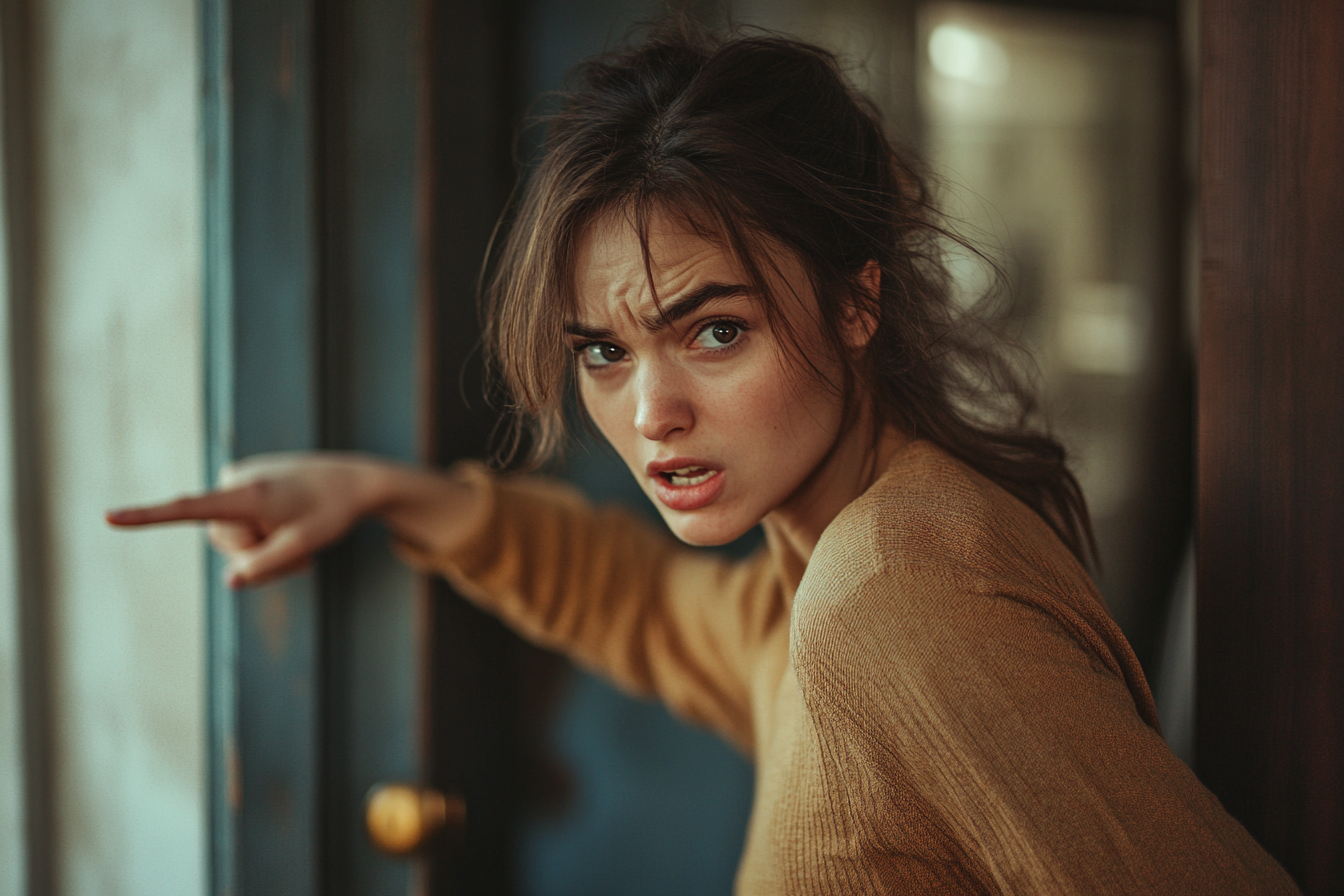 A furious woman pointing to a door | Source: Midjourney