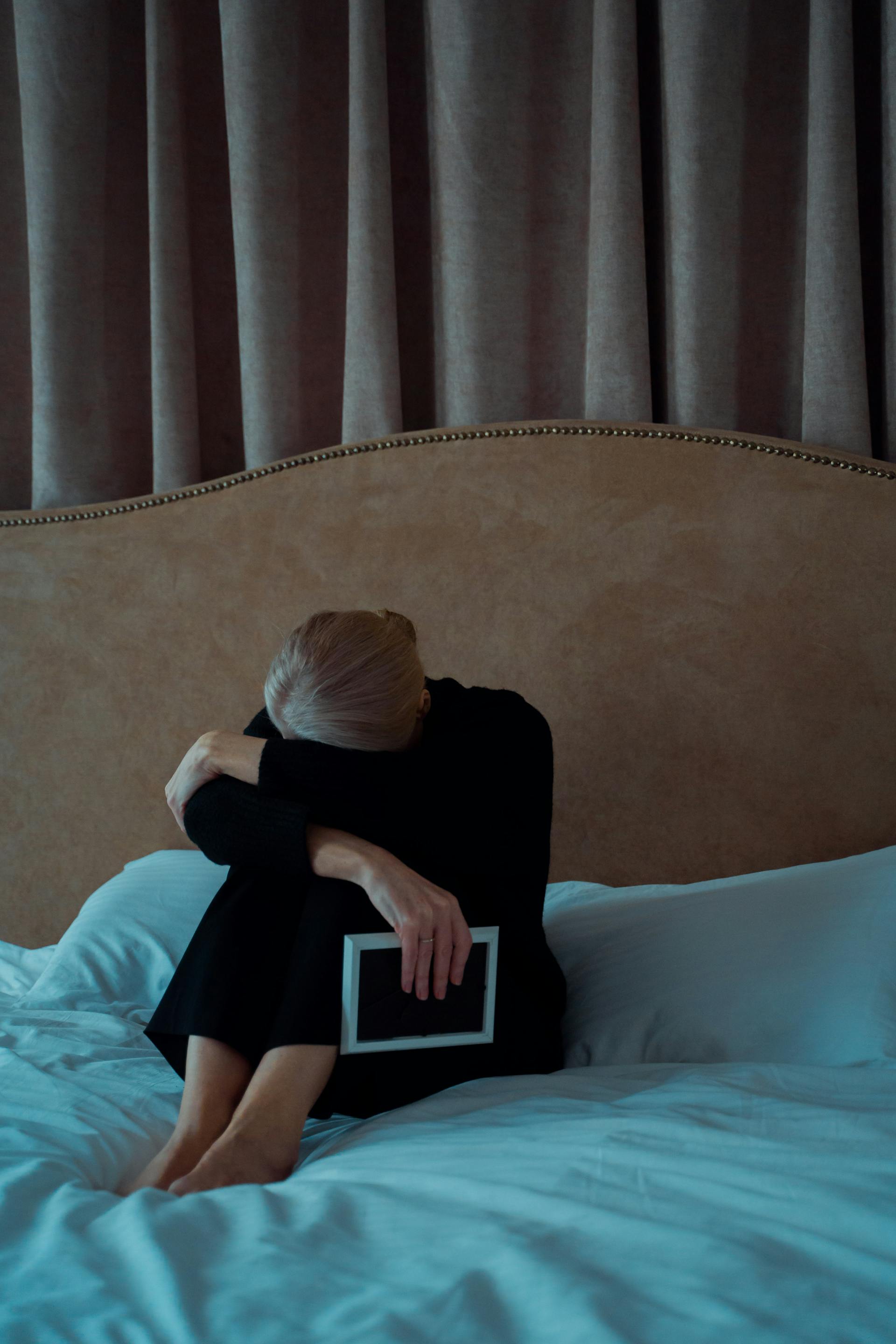 An older woman sitting in her bedroom | Source: Pexels