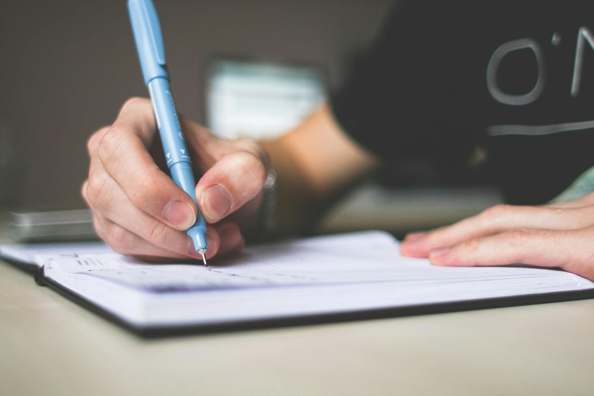 A person writing | Source: Pexels