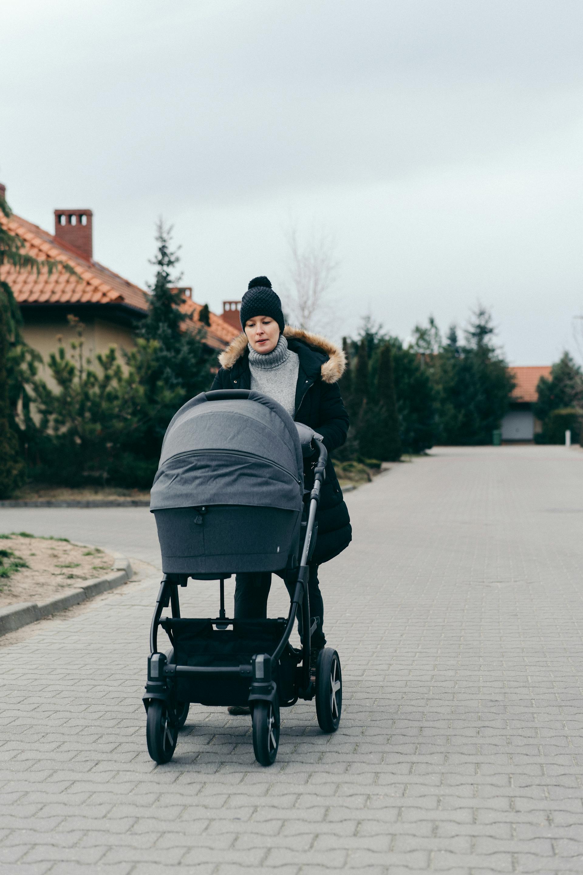 A woman pushing a stroller | Source: Pexels