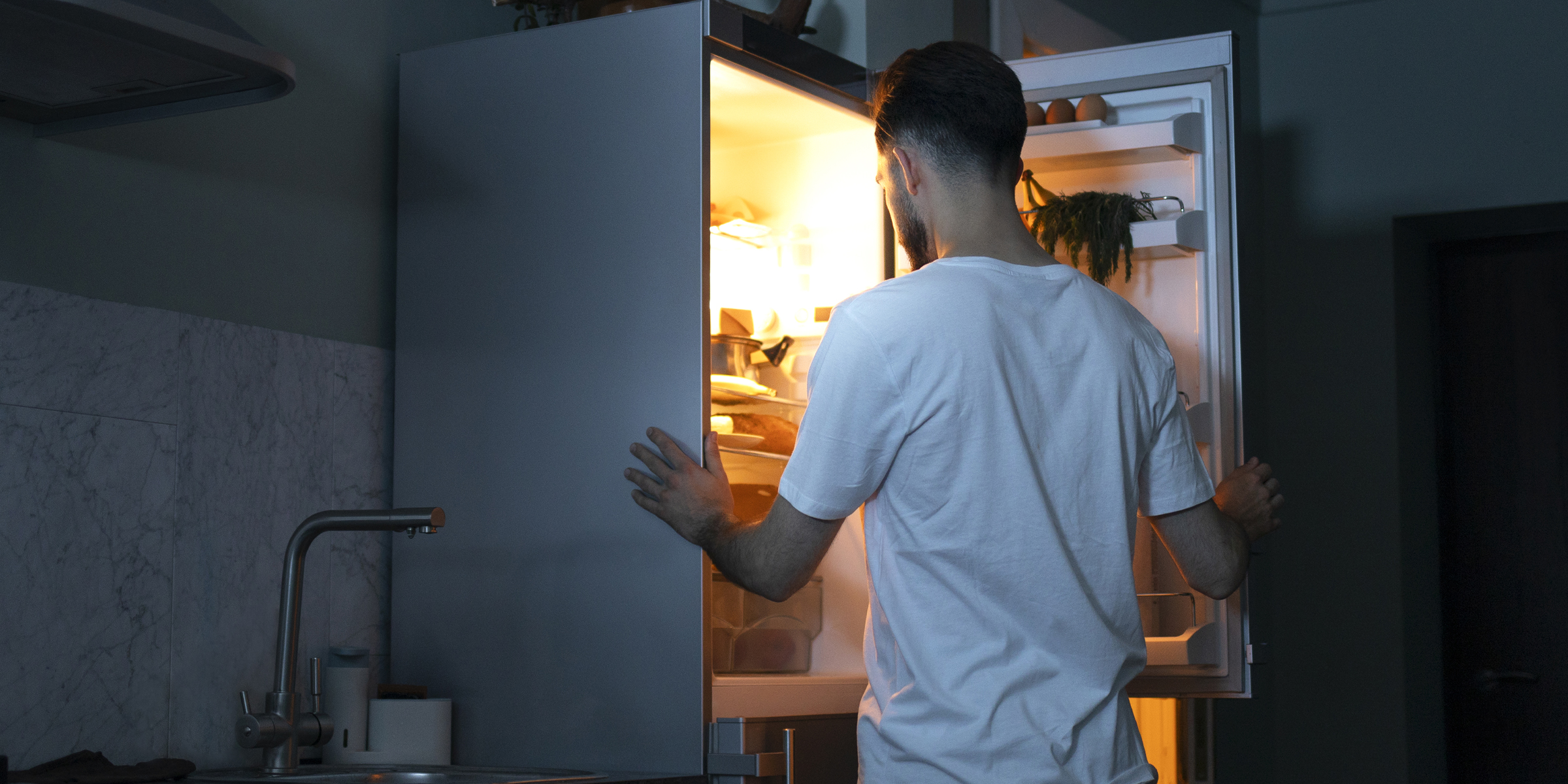 A man standing near a fridge | Source: Freepik