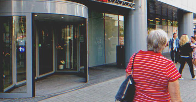 A woman passing in front of a revolving door | Source: Shutterstock