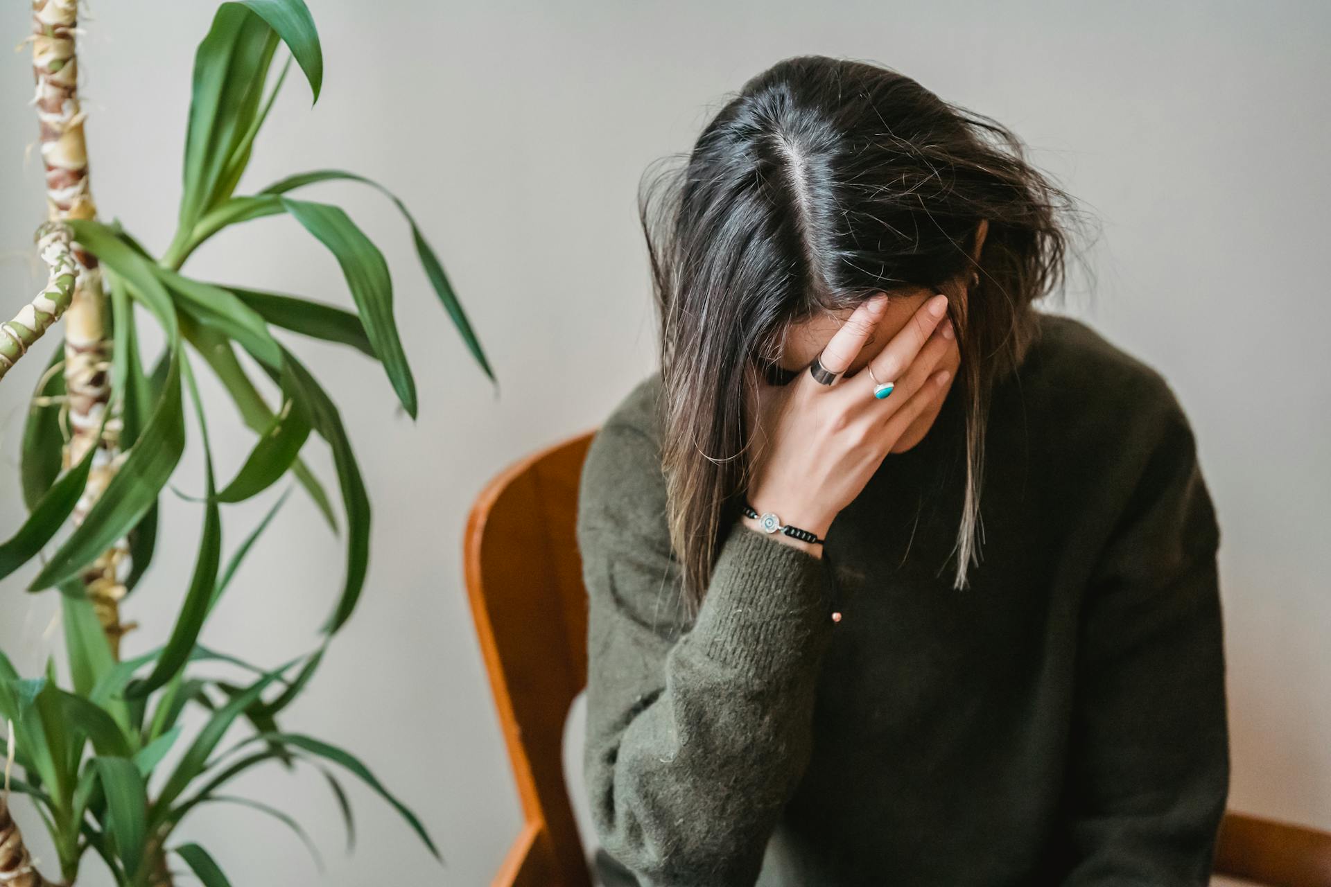 A worried woman covering her face with her hand | Source: Pexels