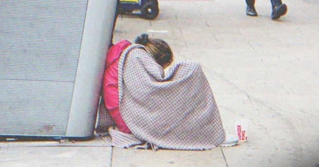 Woman begging while sitting on the street | Source: Shutterstock