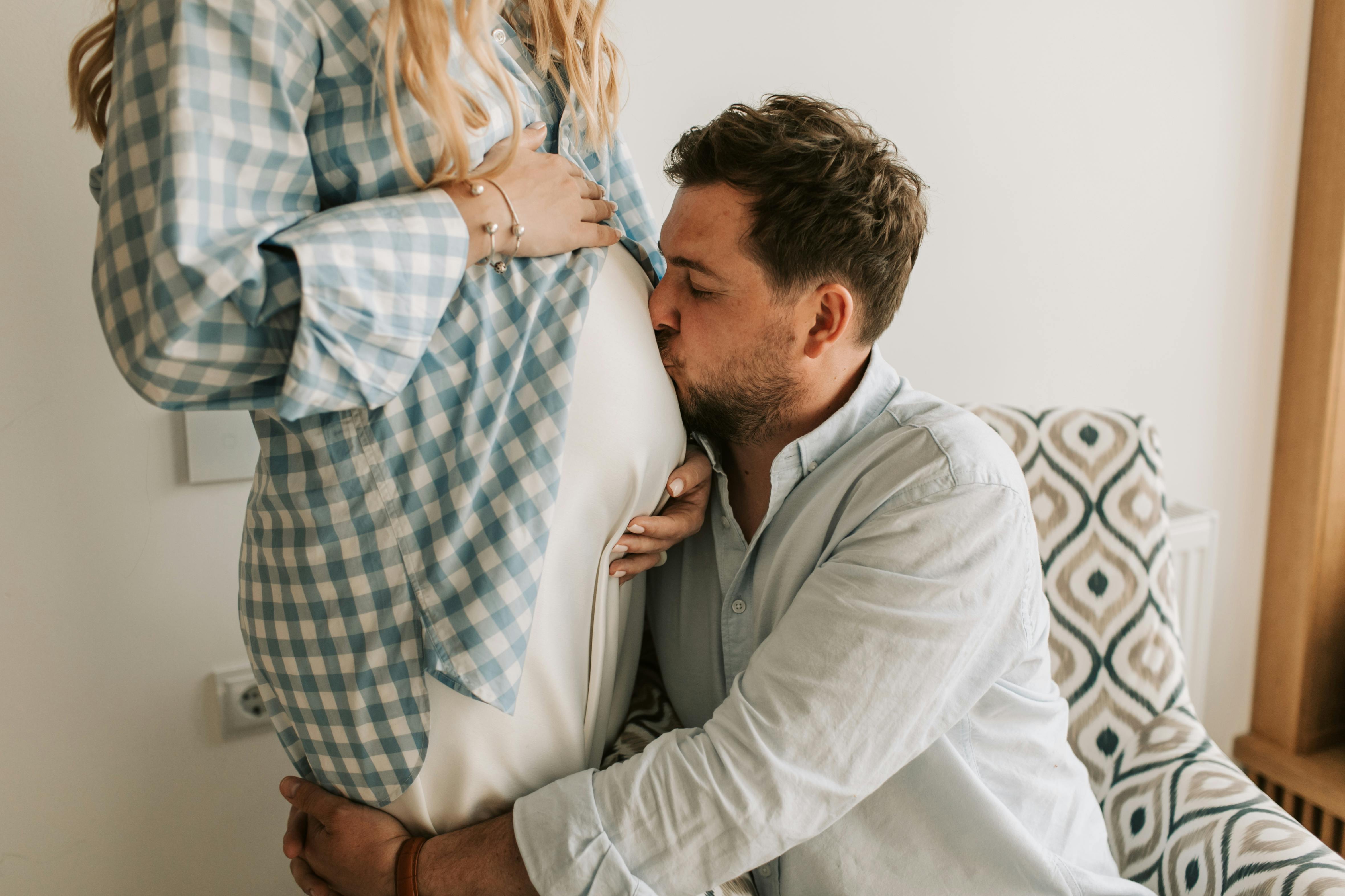 A man doting on his pregnant wife | Source: Midjourney