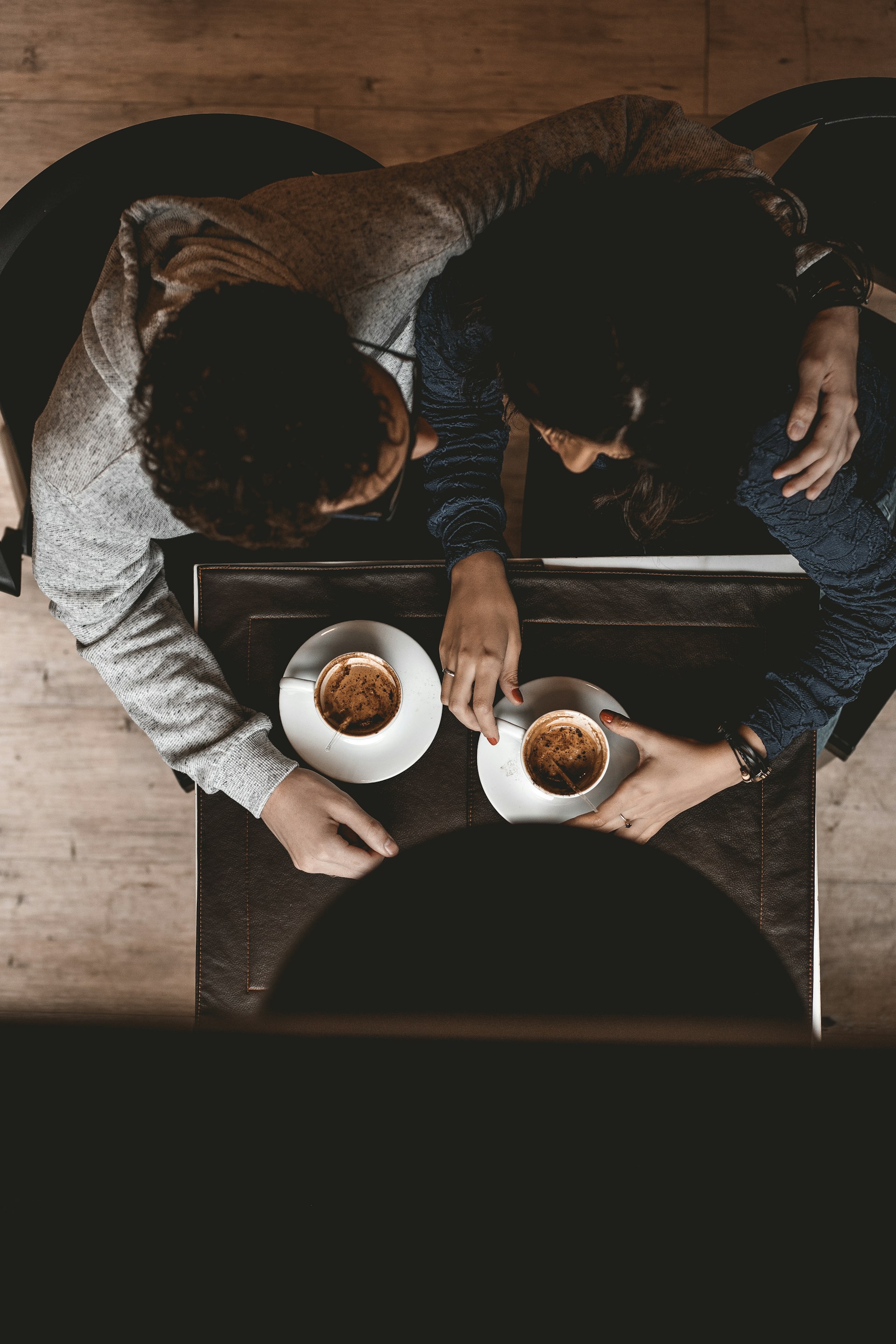 A man embracing a woman during a coffee break | Source: Unsplash